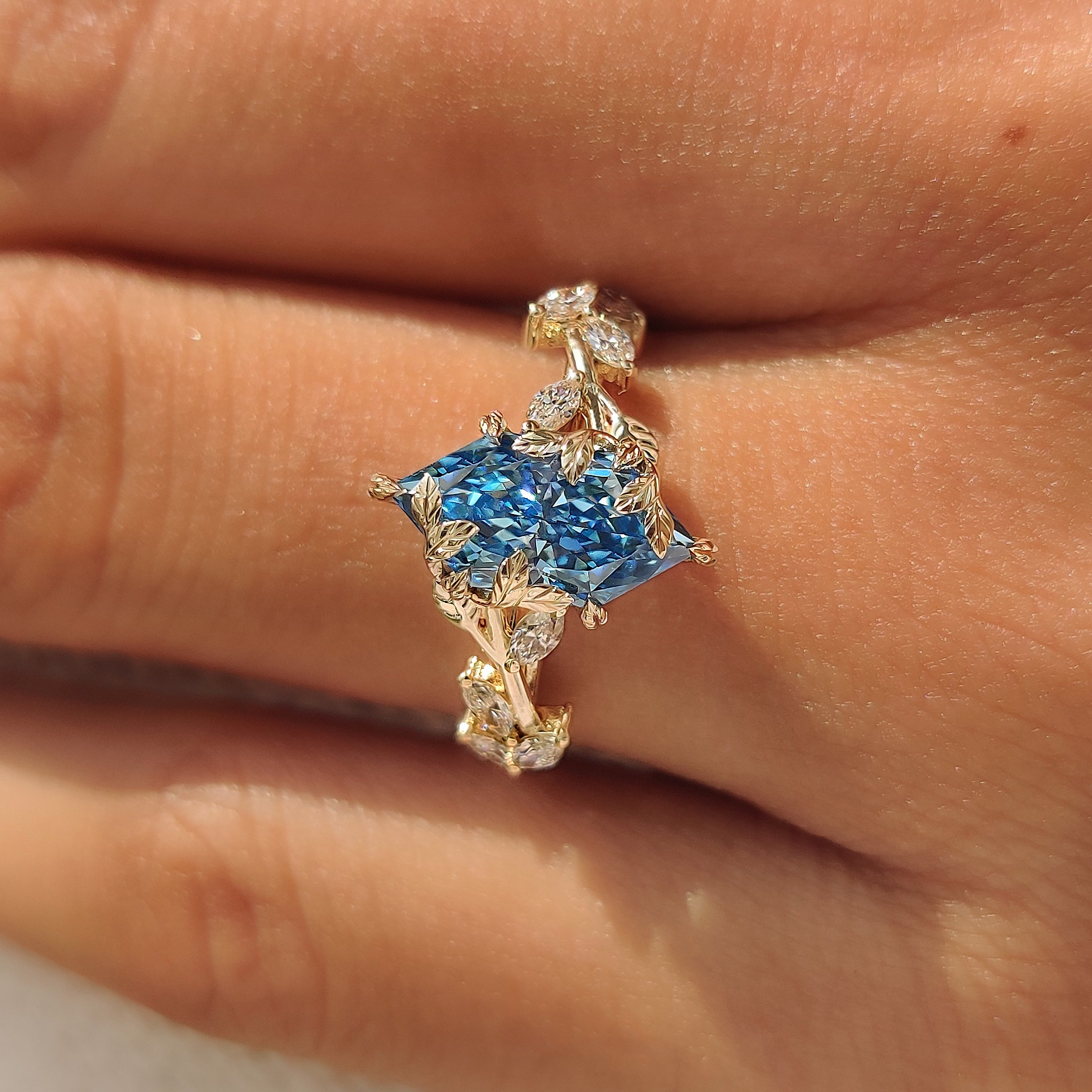 Marquise side stones along the leafy engagement ring band.
