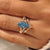 Marquise and round side stones on a blue Dutch marquise ring.
