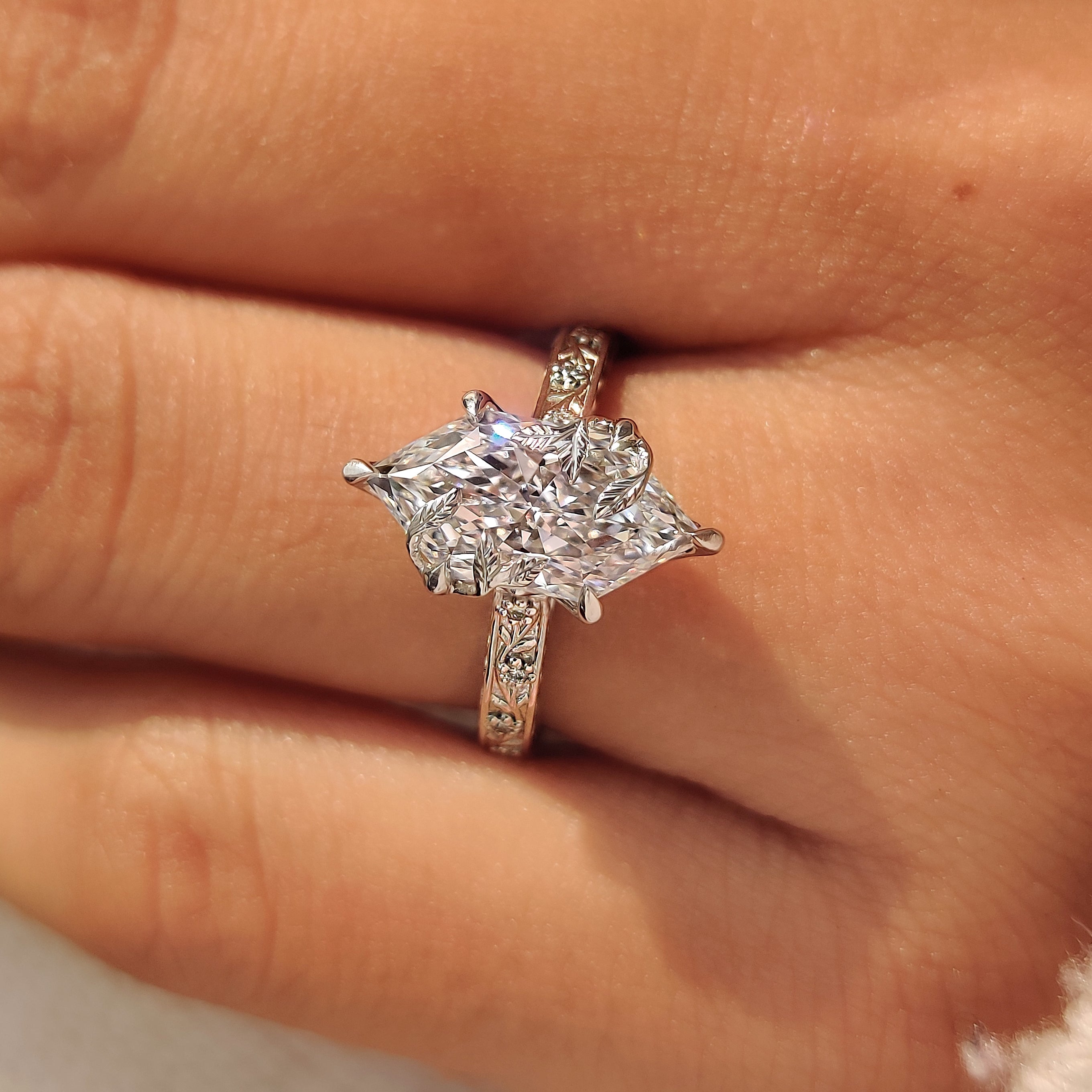 Six claw prongs securing dutch marquise center diamond.
