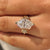 Leaf and sakura flower details around a Dutch marquise center diamond.
