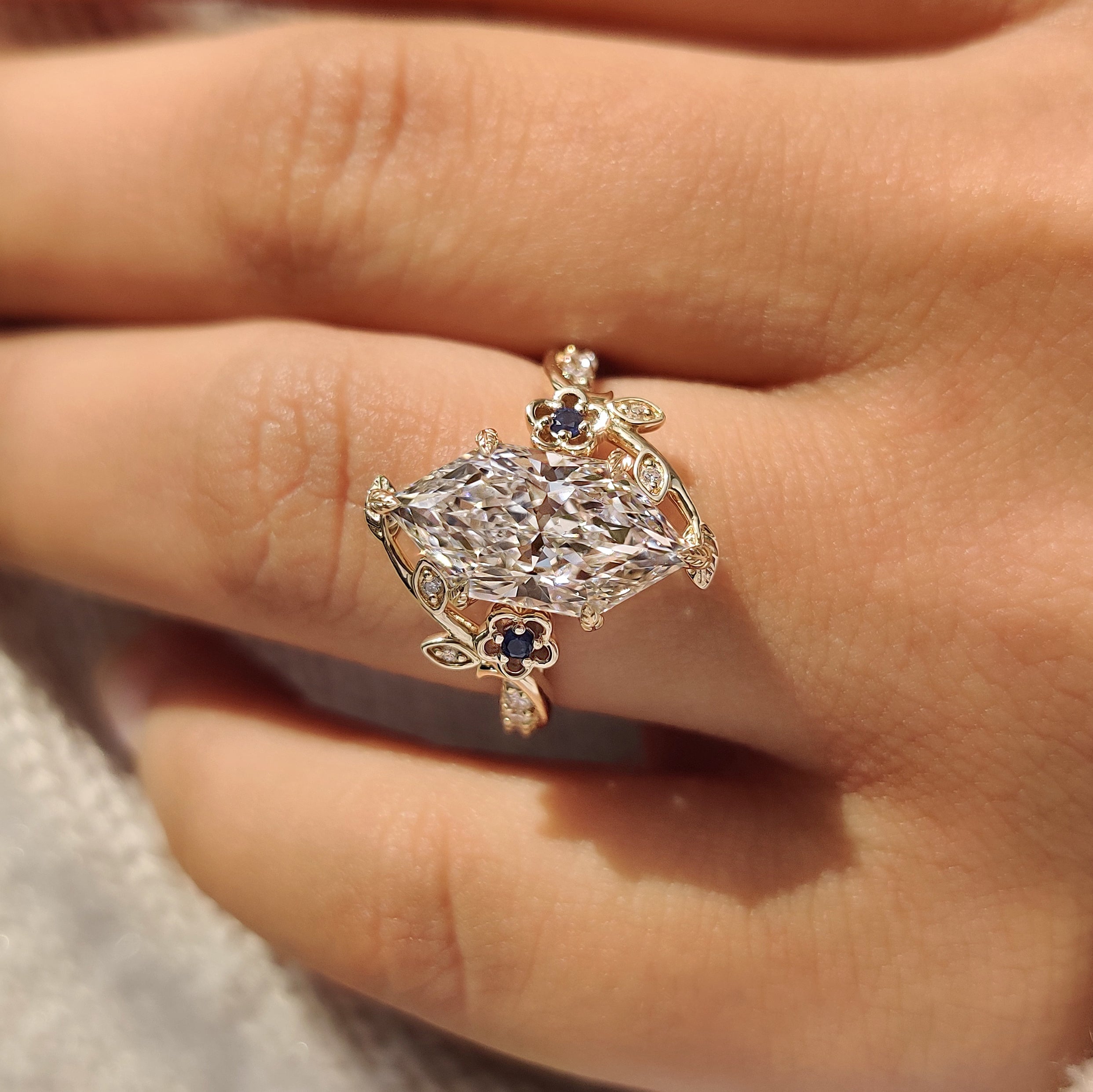 Nature inspired dutch marquise ring with blue sapphire side stones

