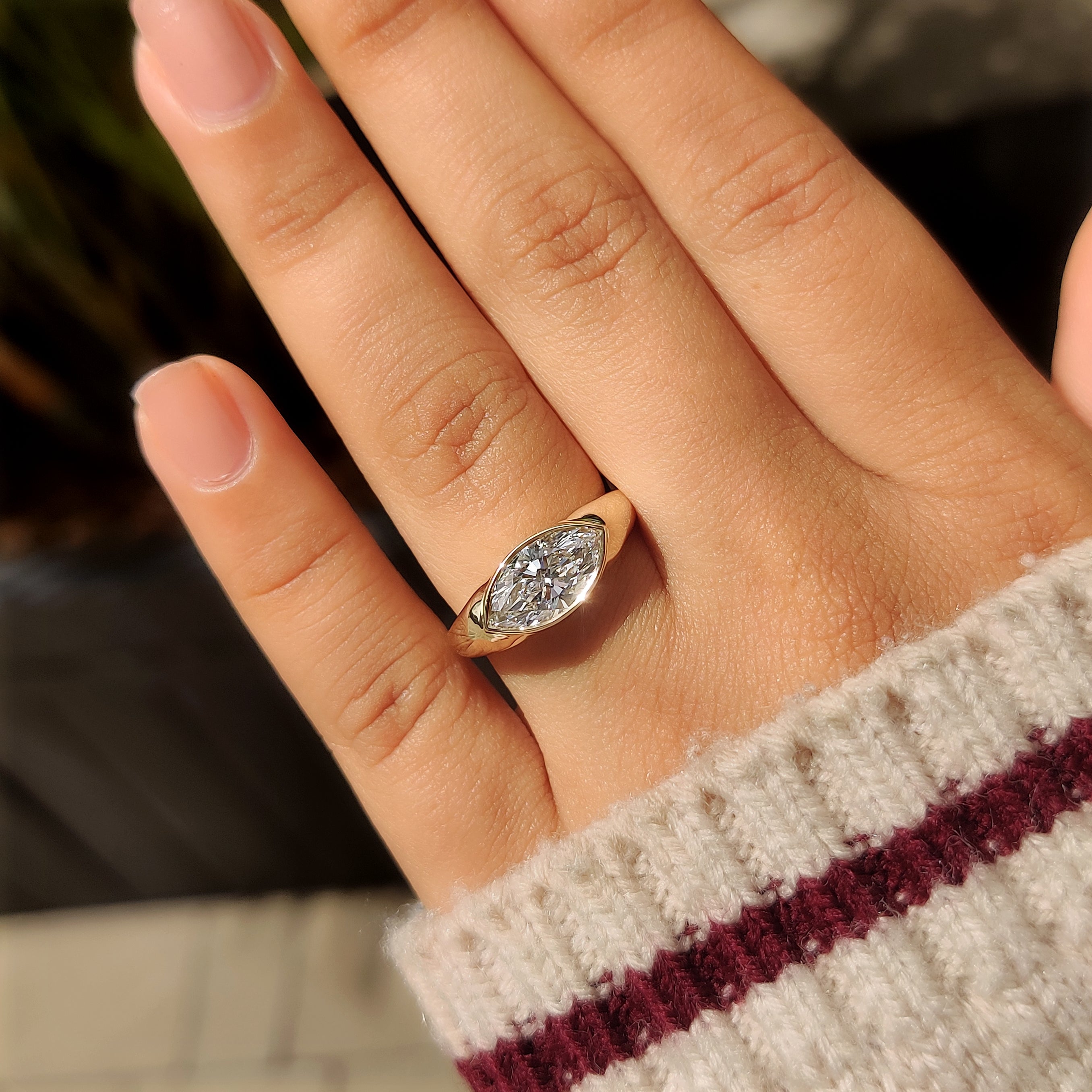 Full bezel setting around marquise diamond
