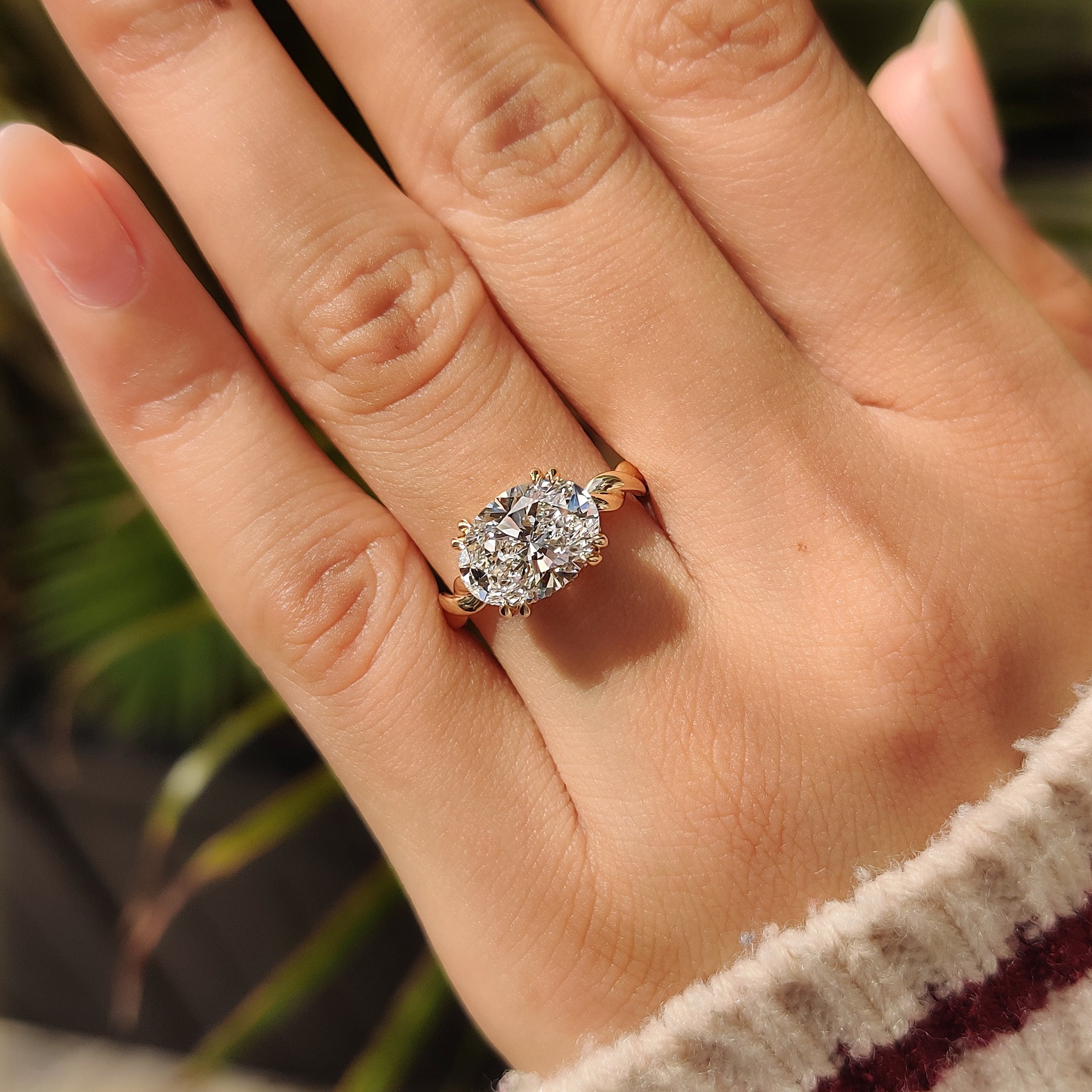 Oval cut solitaire ring with hidden halo round diamonds
