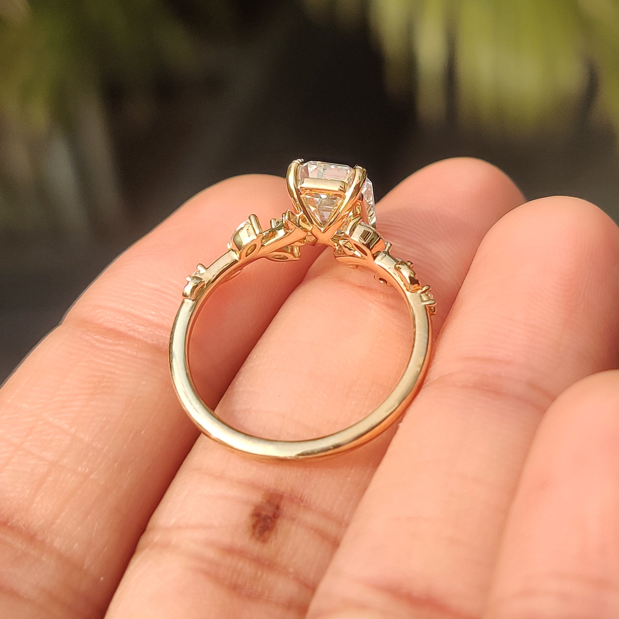 Handmade ring with leaf style prong and emerald cut diamond
