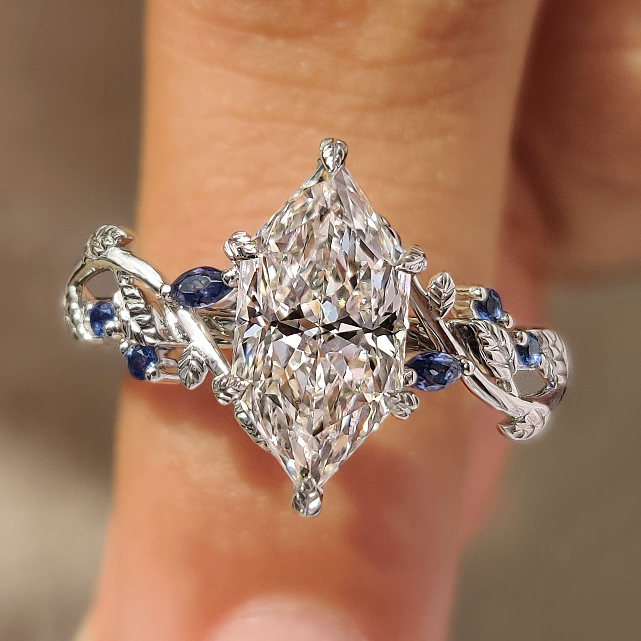 Dutch marquise diamond ring with blue sapphire marquise and round side stones
