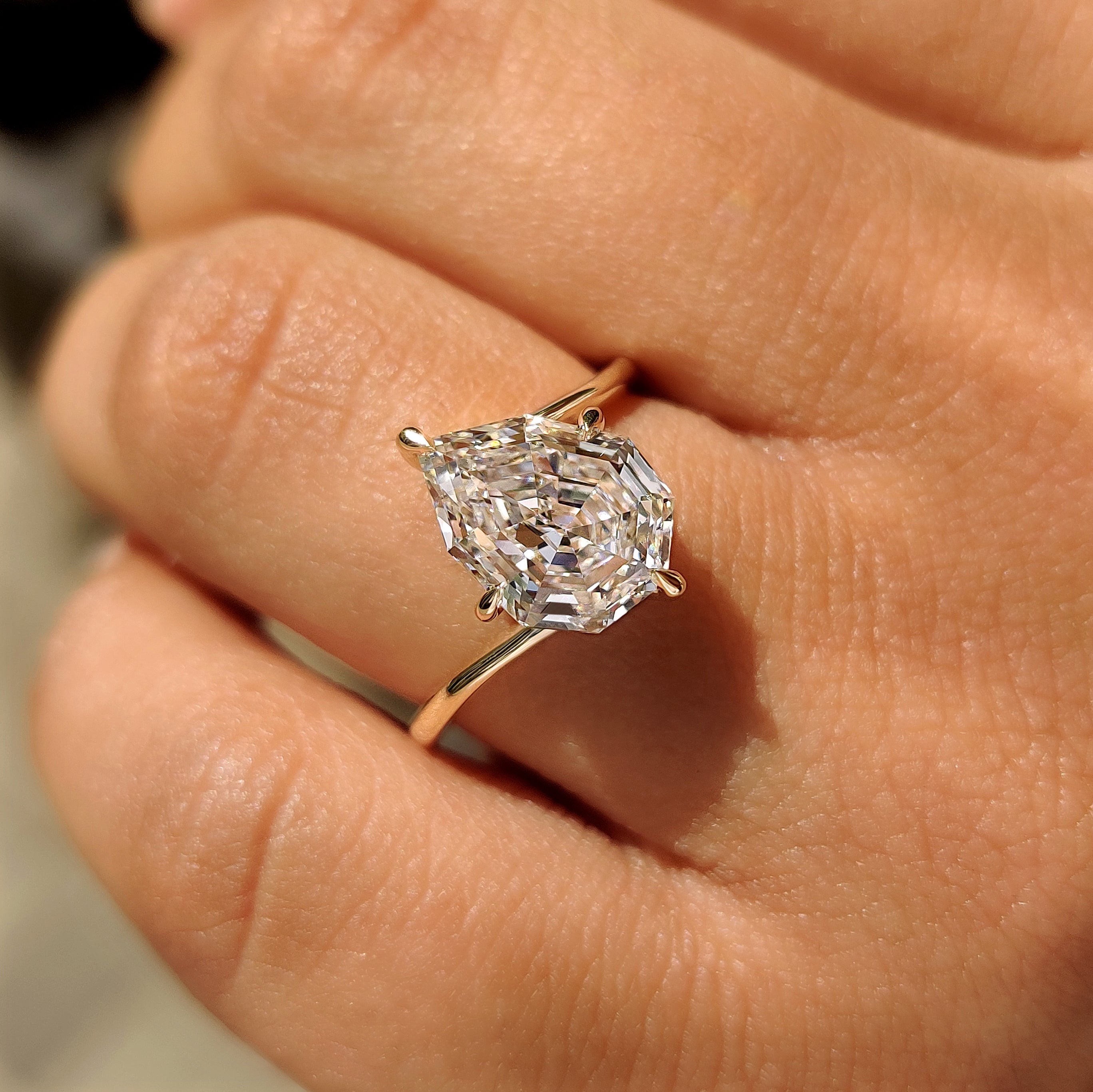 Pear step cut lab diamond ring with bypass band.
