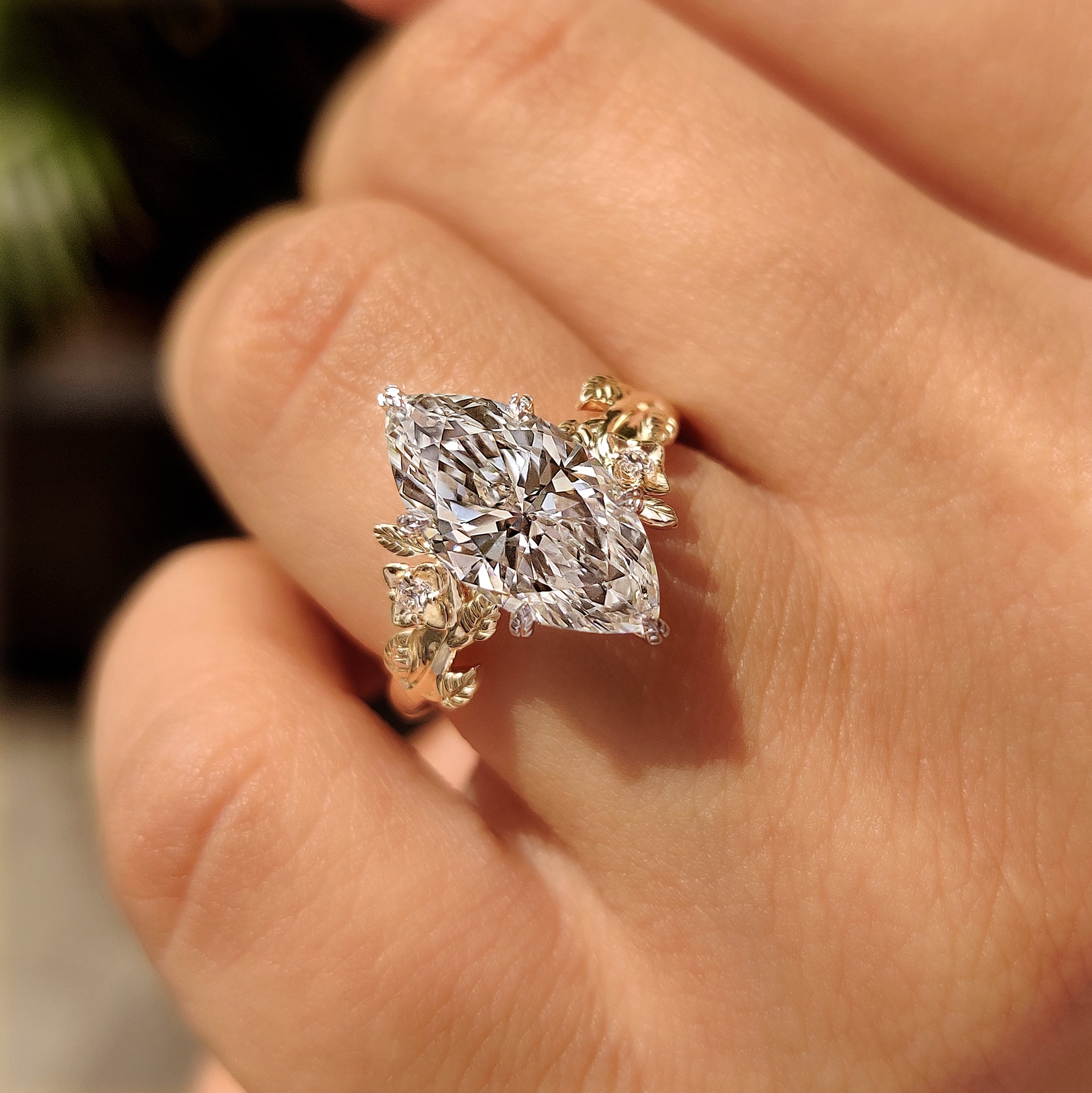 Marquise center diamond ring with leaf inspired shank
