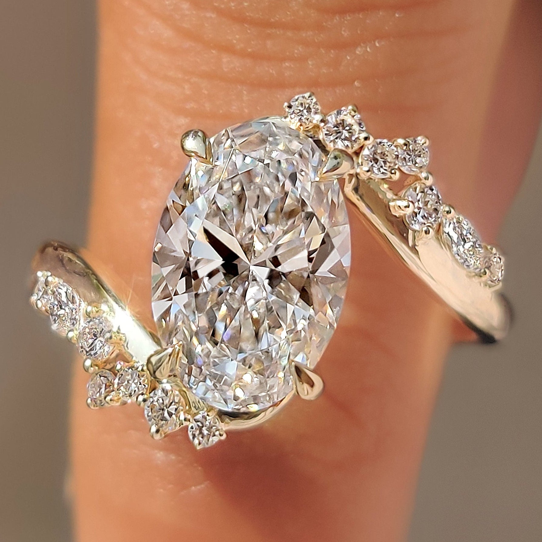 Oval cut center diamond with marquise and round side stones.
