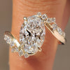 Oval cut center diamond with marquise and round side stones.
