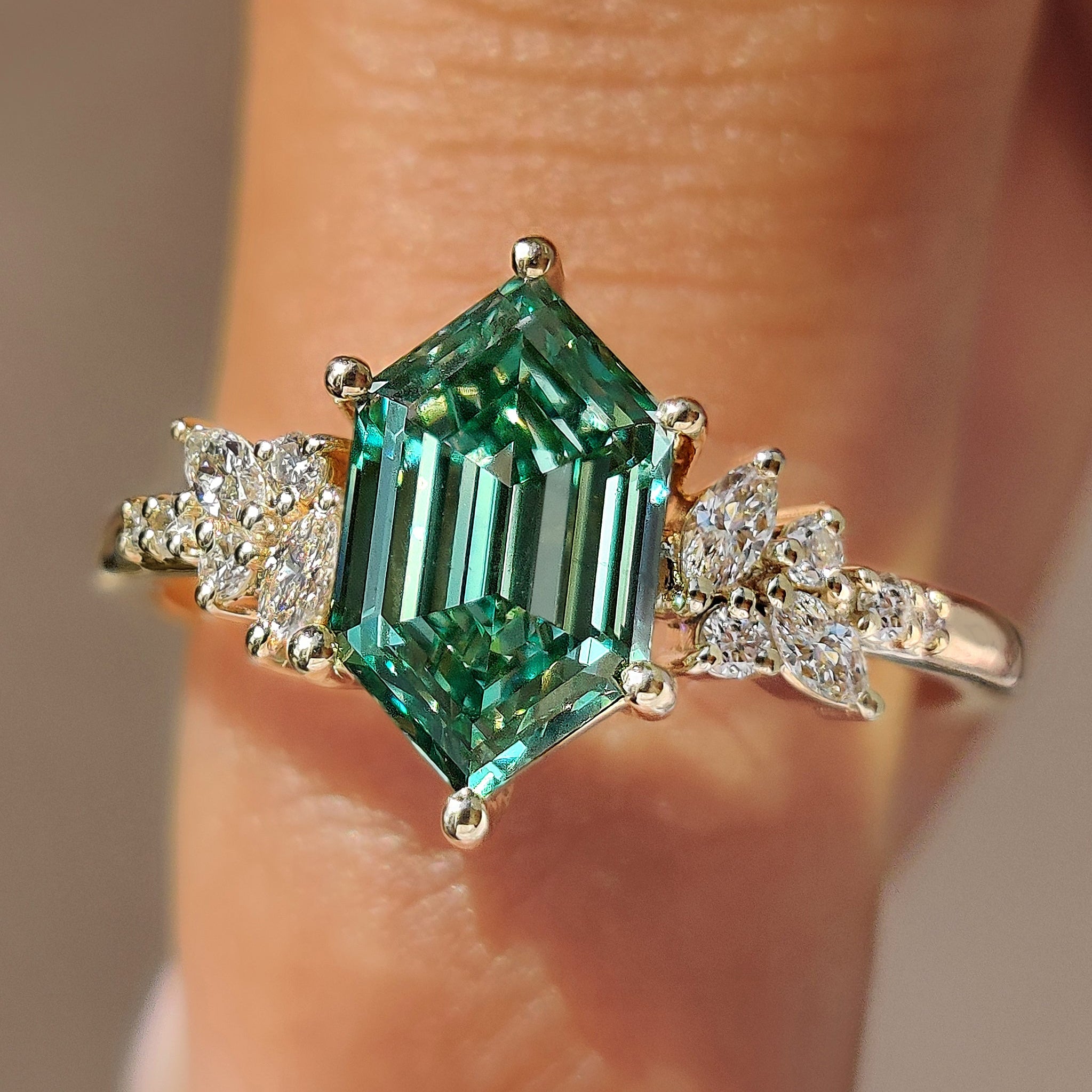 Green hexagon step cut diamond ring.
