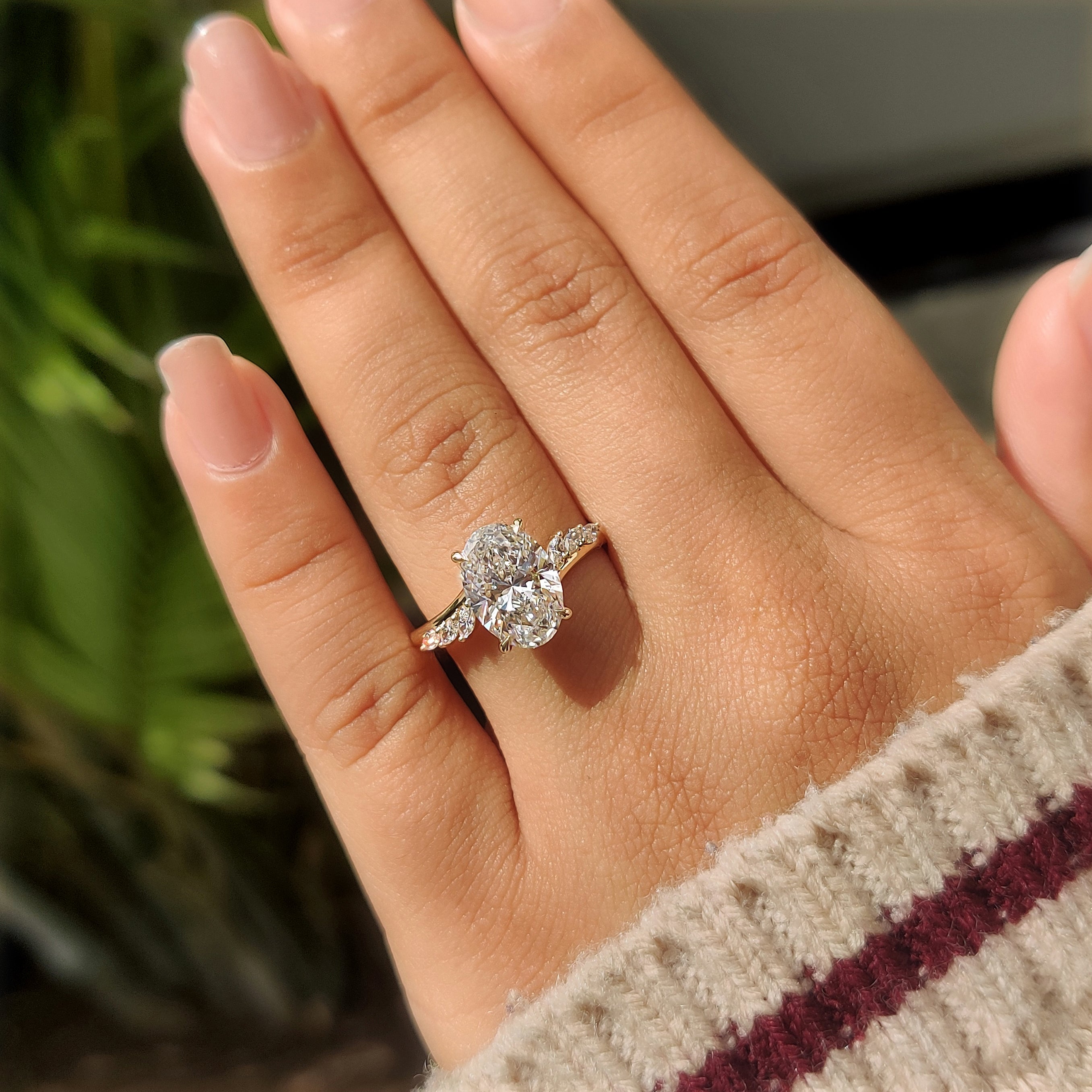 Oval centre diamond ring with round hidden halo.
