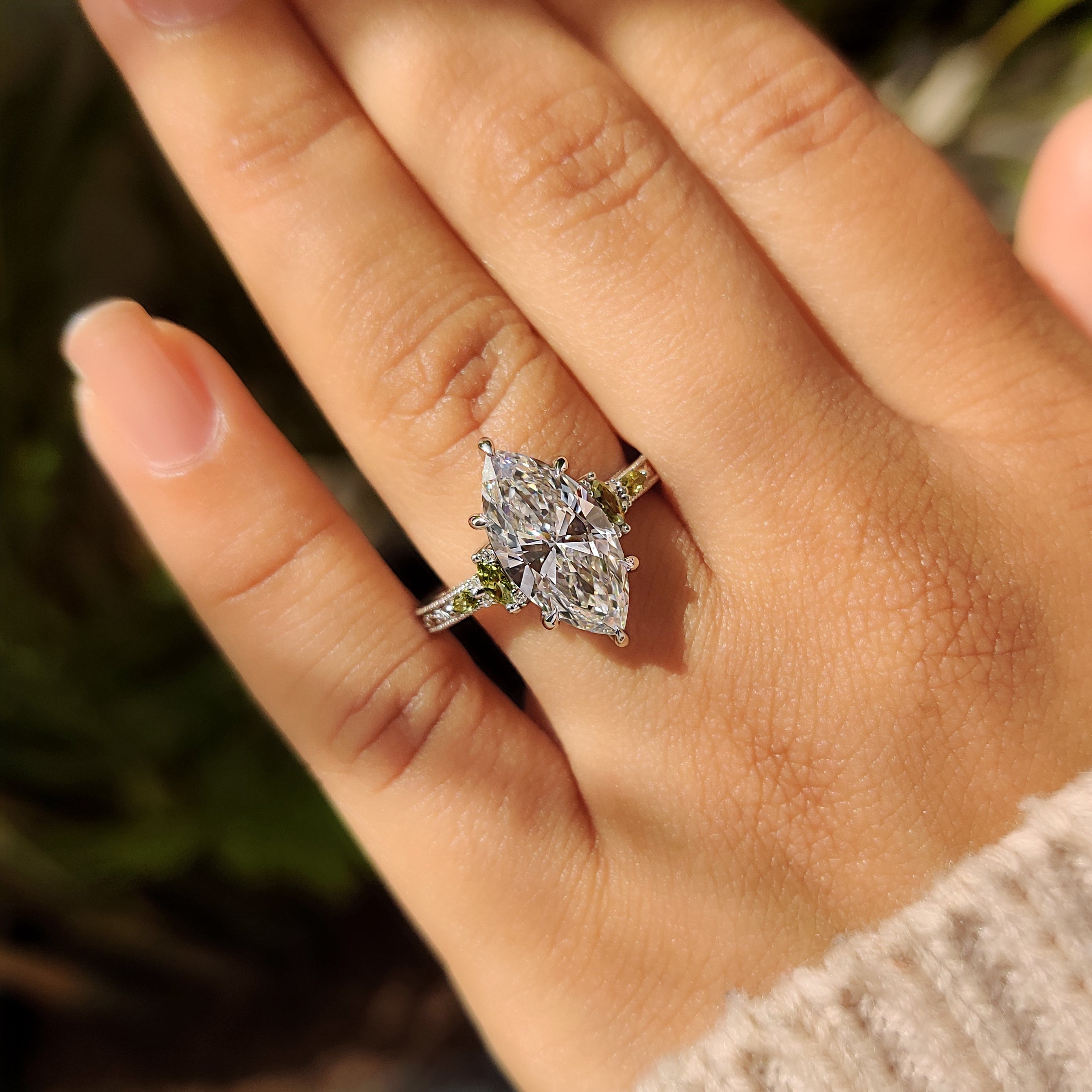 Marquise engagement ring with milgrain and round side stones

