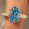 Blue oval engagement ring with floral design
