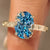Blue oval engagement ring with floral design
