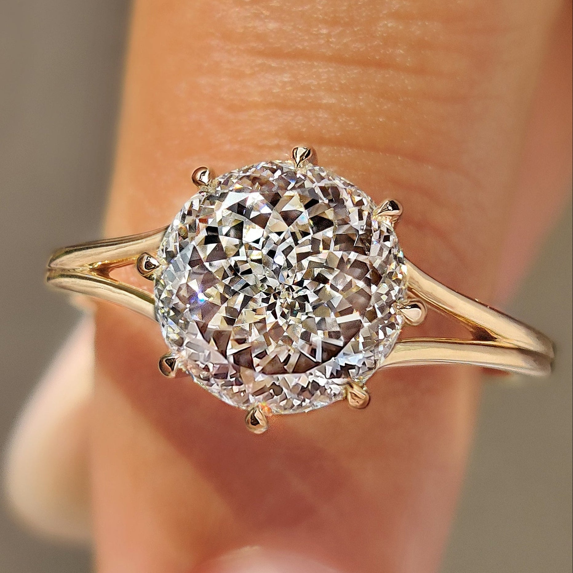 Portuguese cut diamond solitaire engagement ring with split shank.
