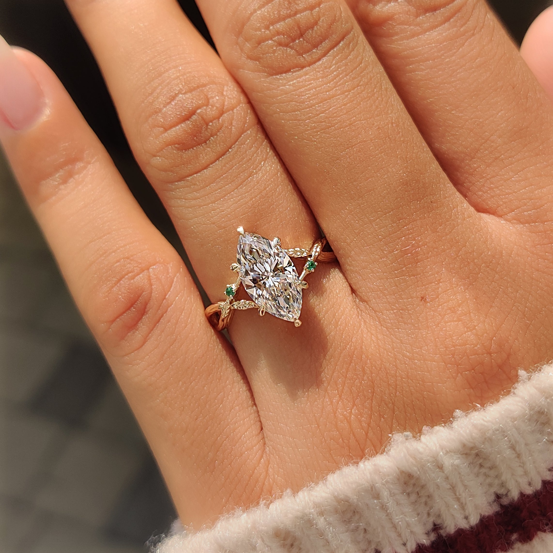 Twisted branch design along the marquise ring shank.
