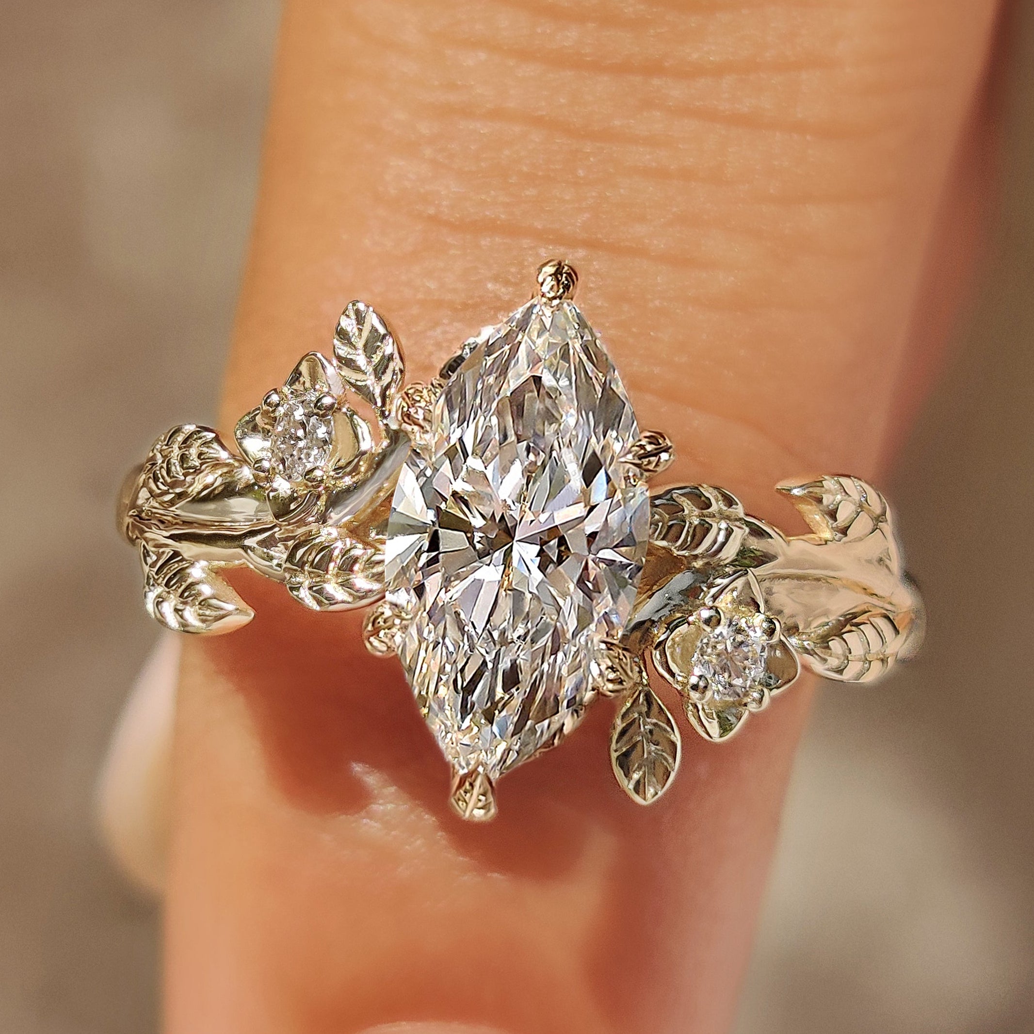 Marquise cut diamond ring with flower and leaf details
