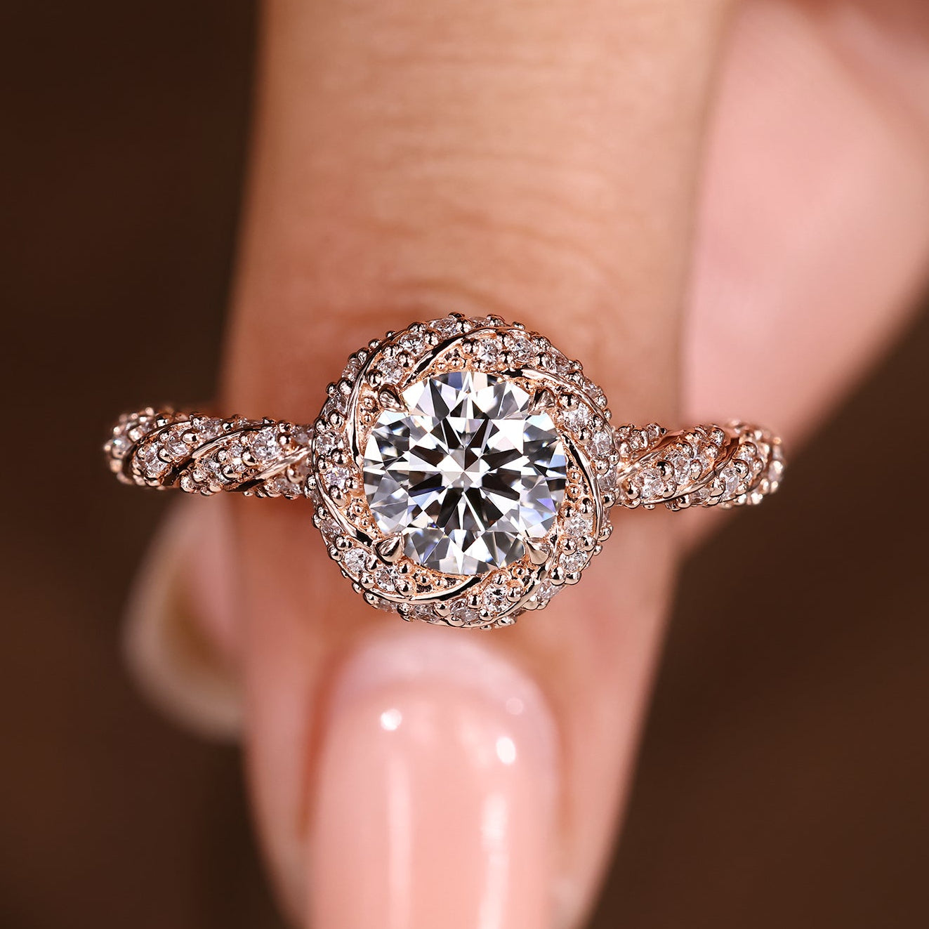 Round cut diamond ring with twisted pave halo design
