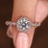 Round cut diamond ring with twisted pave halo design
