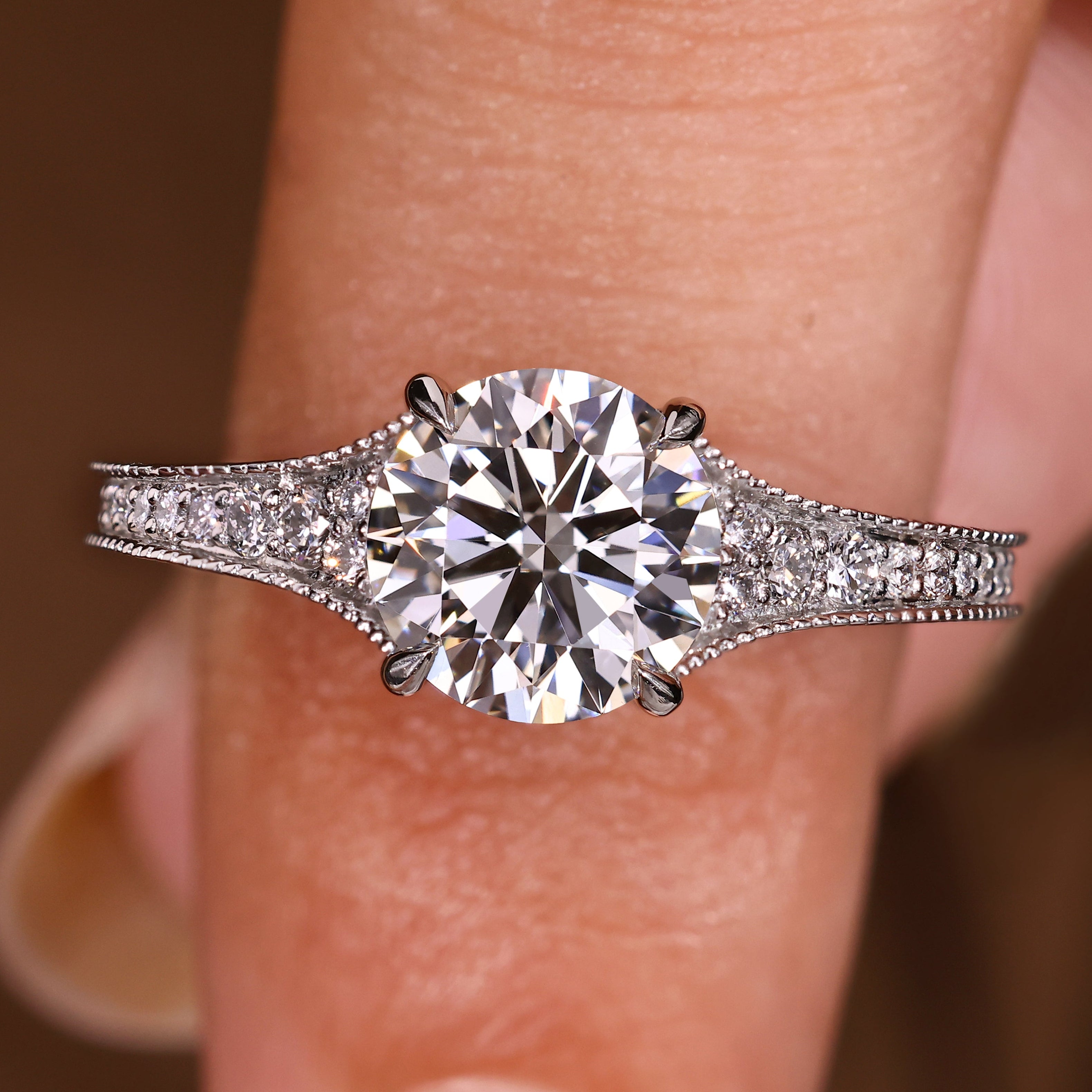 Round diamond engagement ring with milgrain detailing
