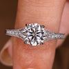 Round diamond engagement ring with milgrain detailing
