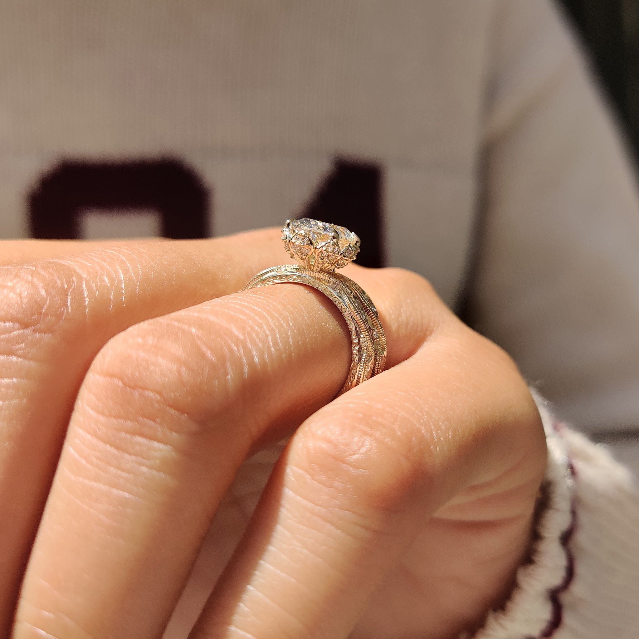 Bridal set with oval diamond and detailed engraved filigree shank.
