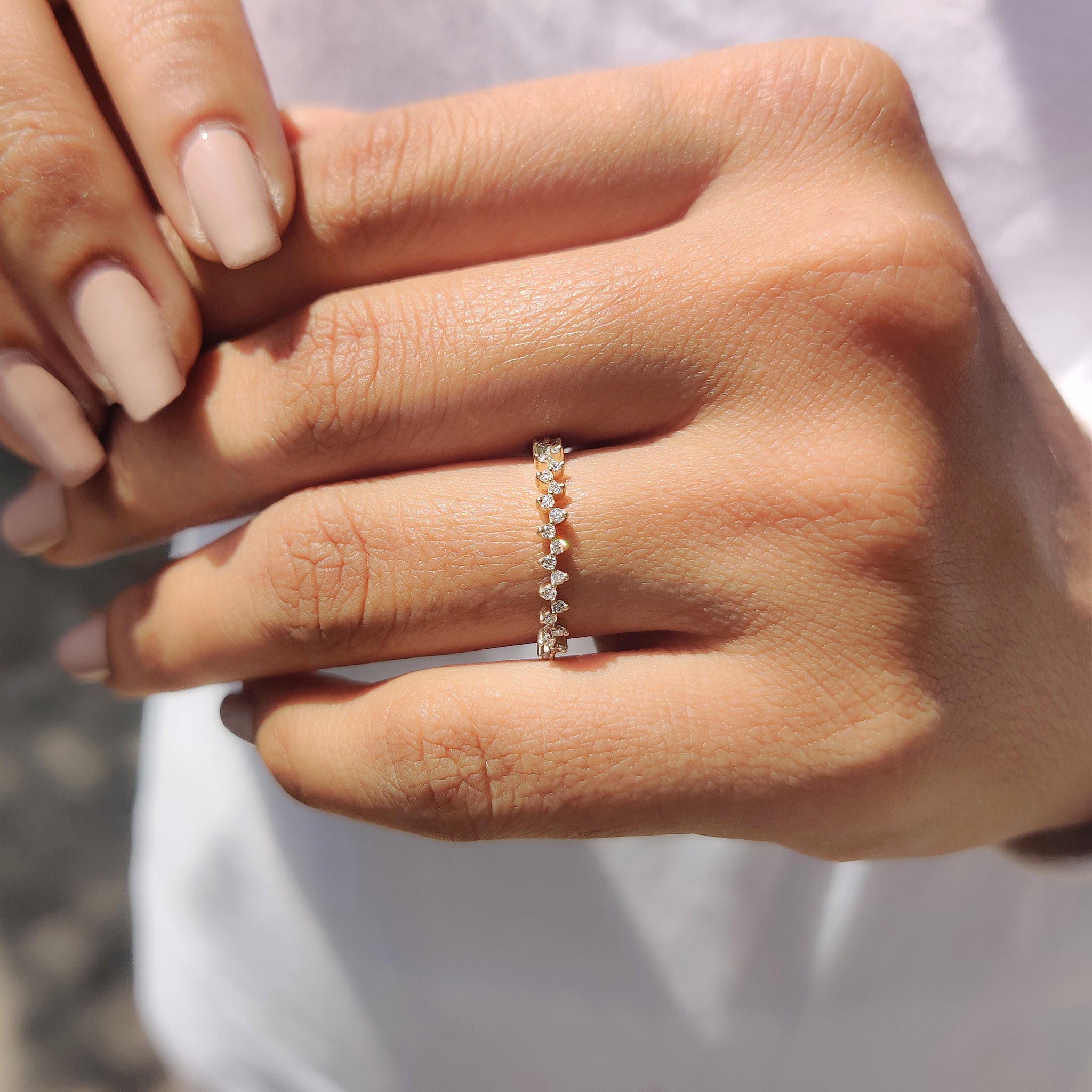 Prong set band holding a round cut diamond at the center.
