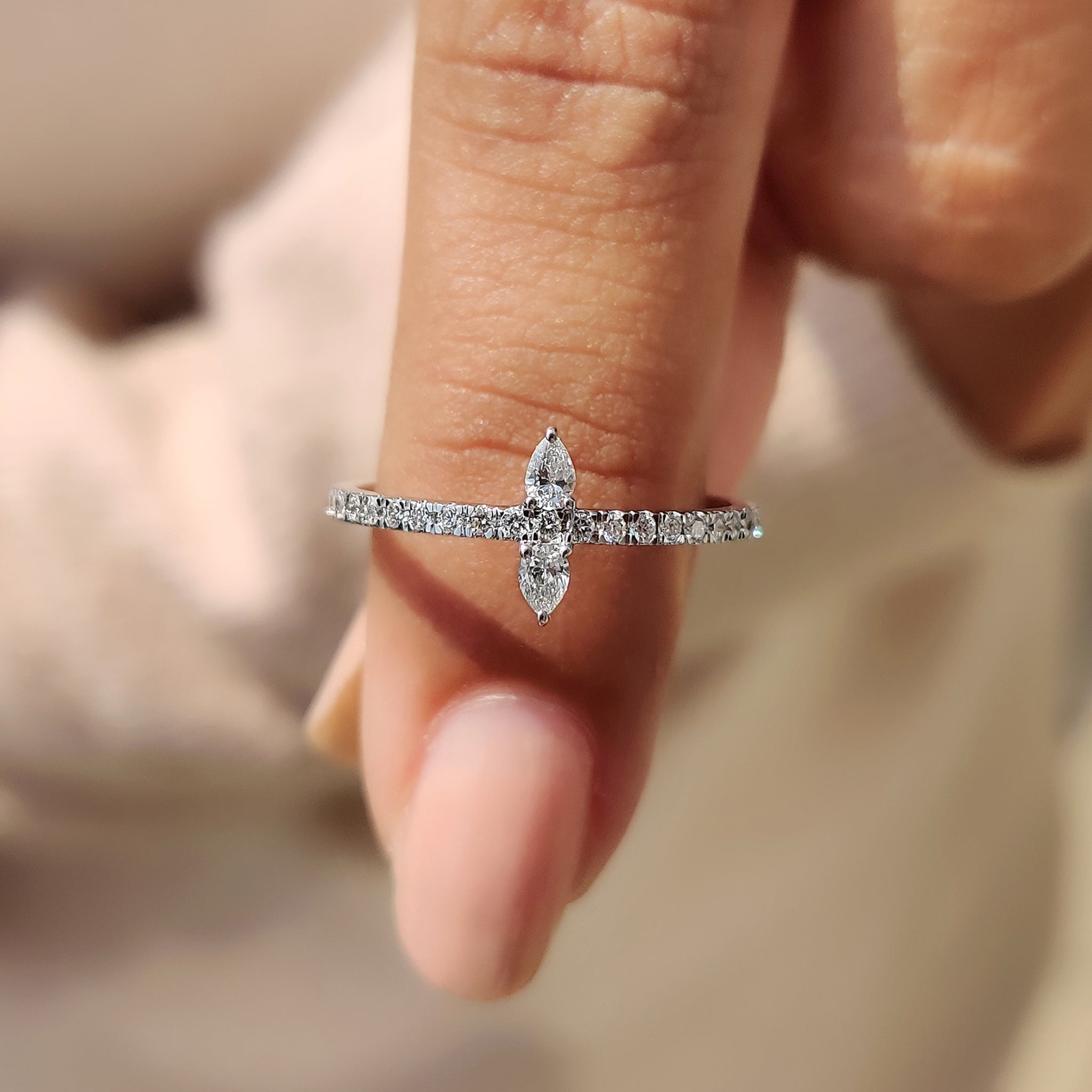 2 stone diamond ring with pear diamonds in a prong setting.
