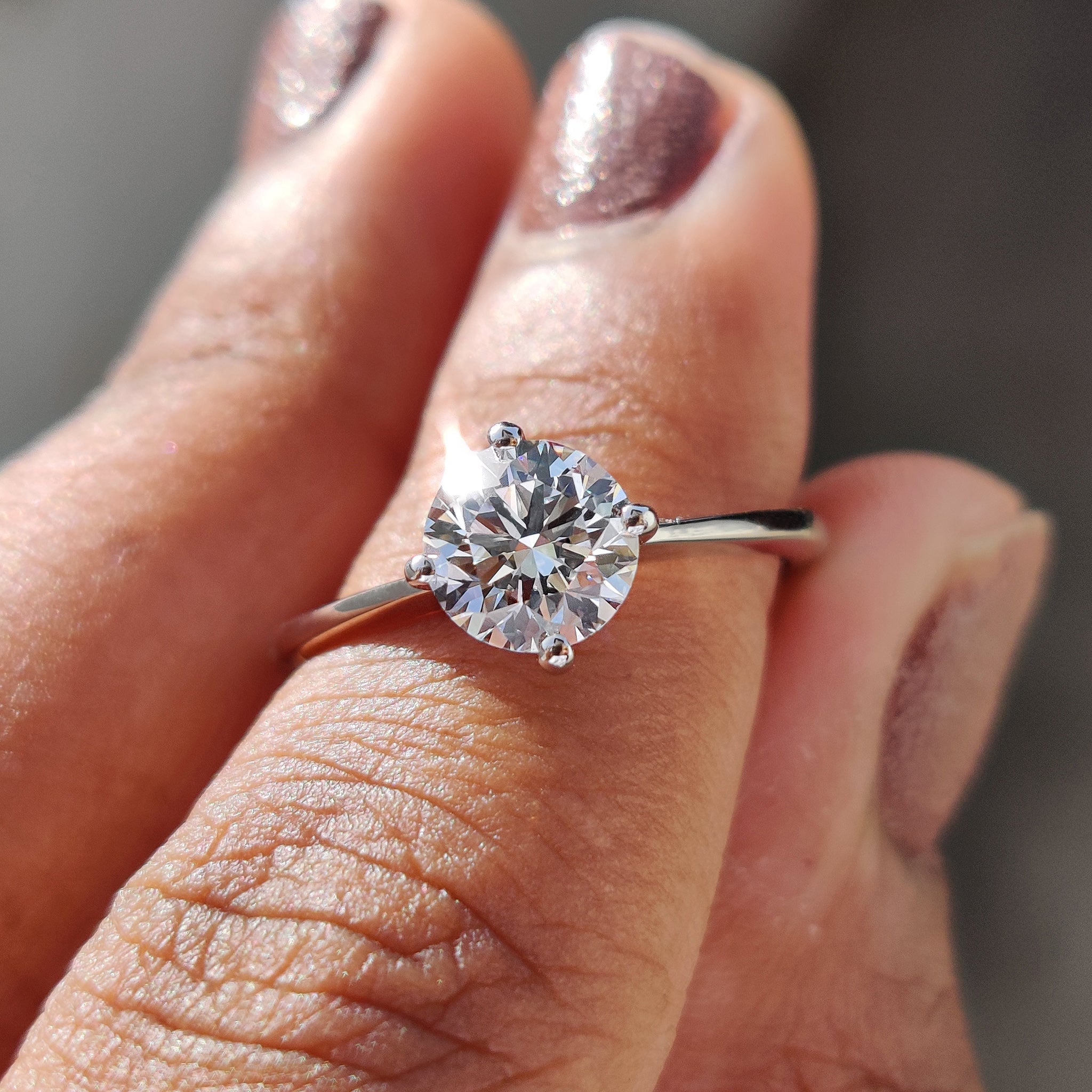 Round solitaire engagement ring with a brilliant lab-grown diamond.
