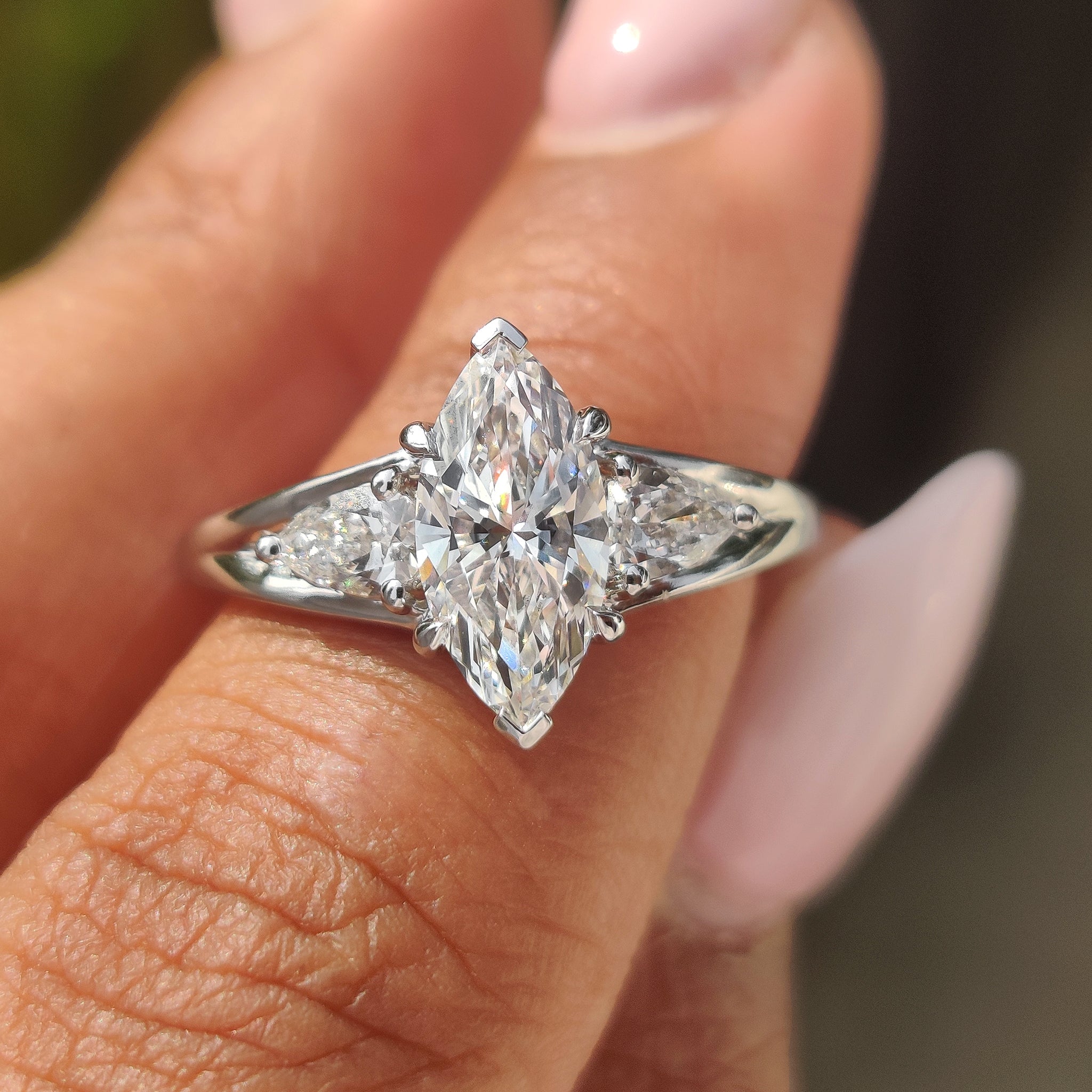 Marquise and pear diamond ring with split shank design.
