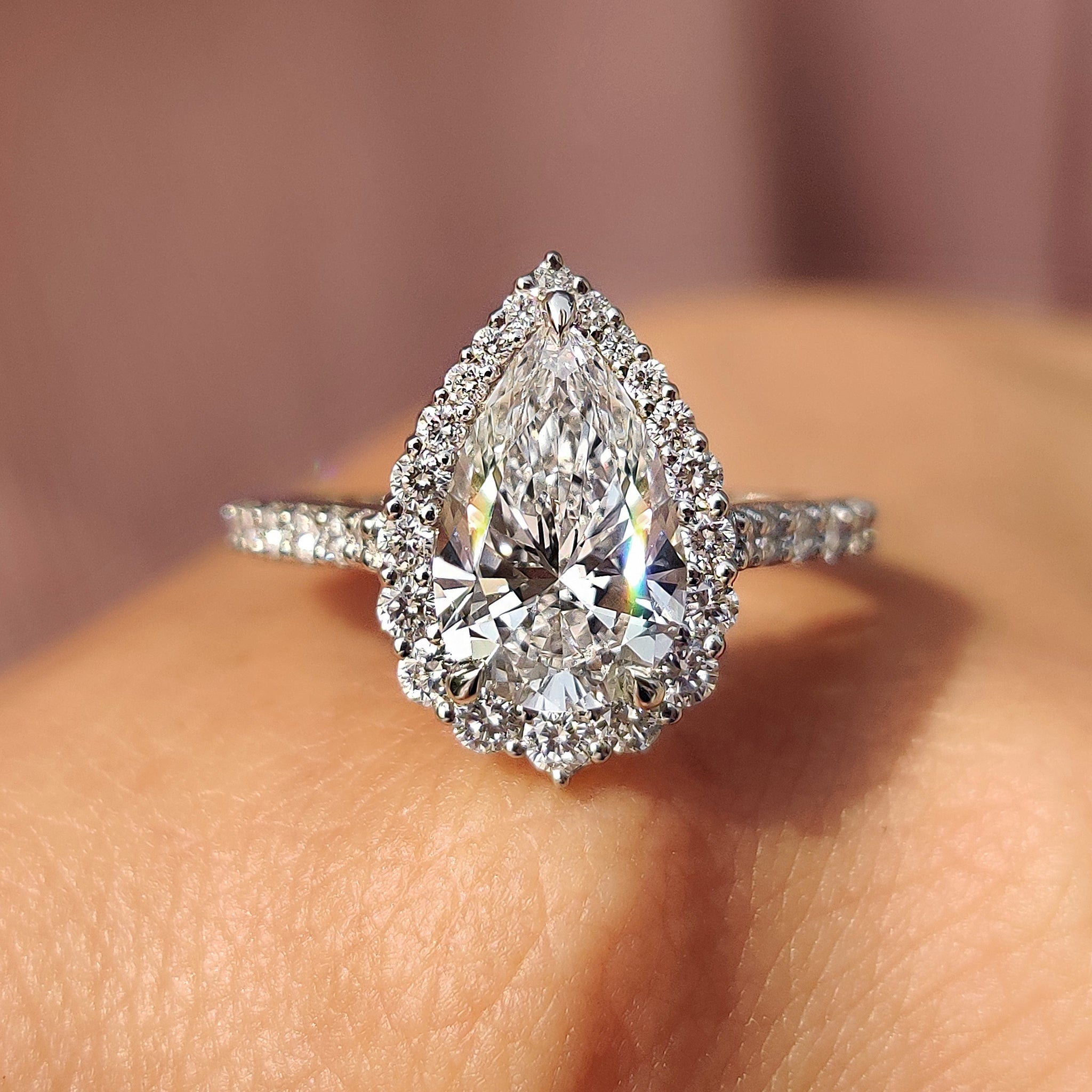 Pear shaped halo engagement ring with stunning design.
