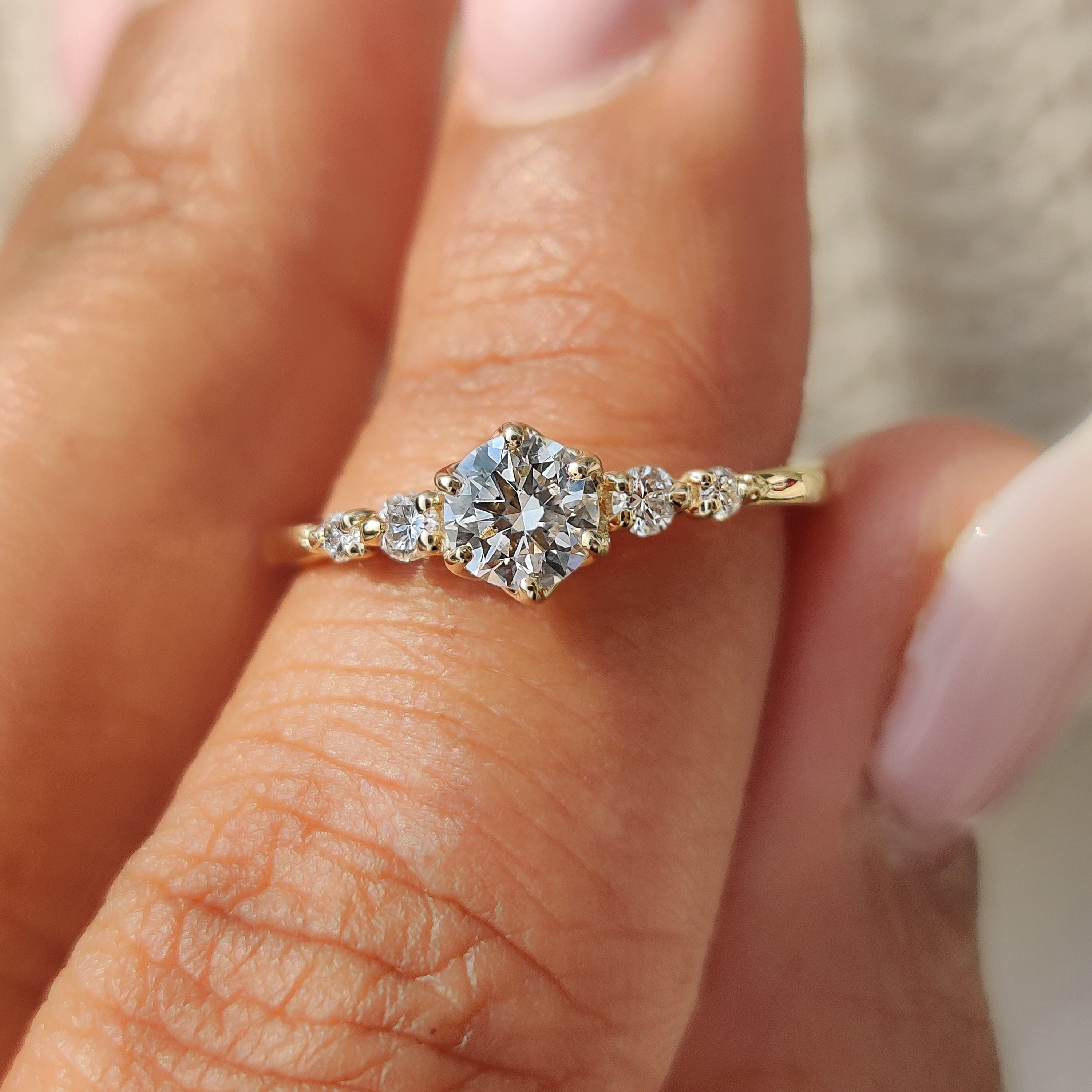 A stunning 5 stone diamond ring featuring brilliant-cut diamonds set elegantly on a sleek band.
