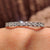White gold eternity band with a classic design and sparkling diamonds.
