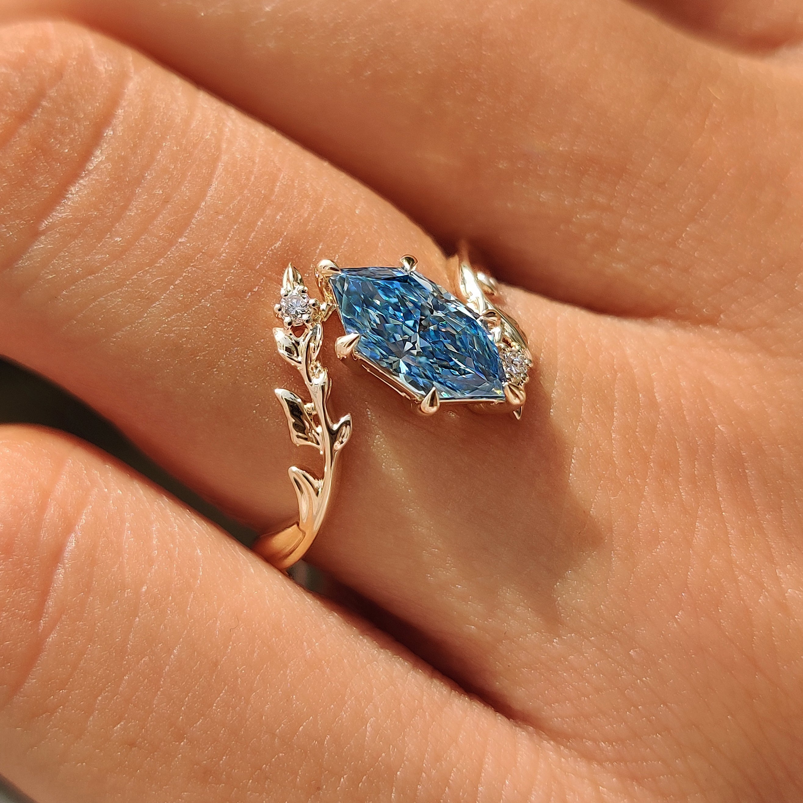 Bypass vine shank design on a blue Dutch marquise ring.
