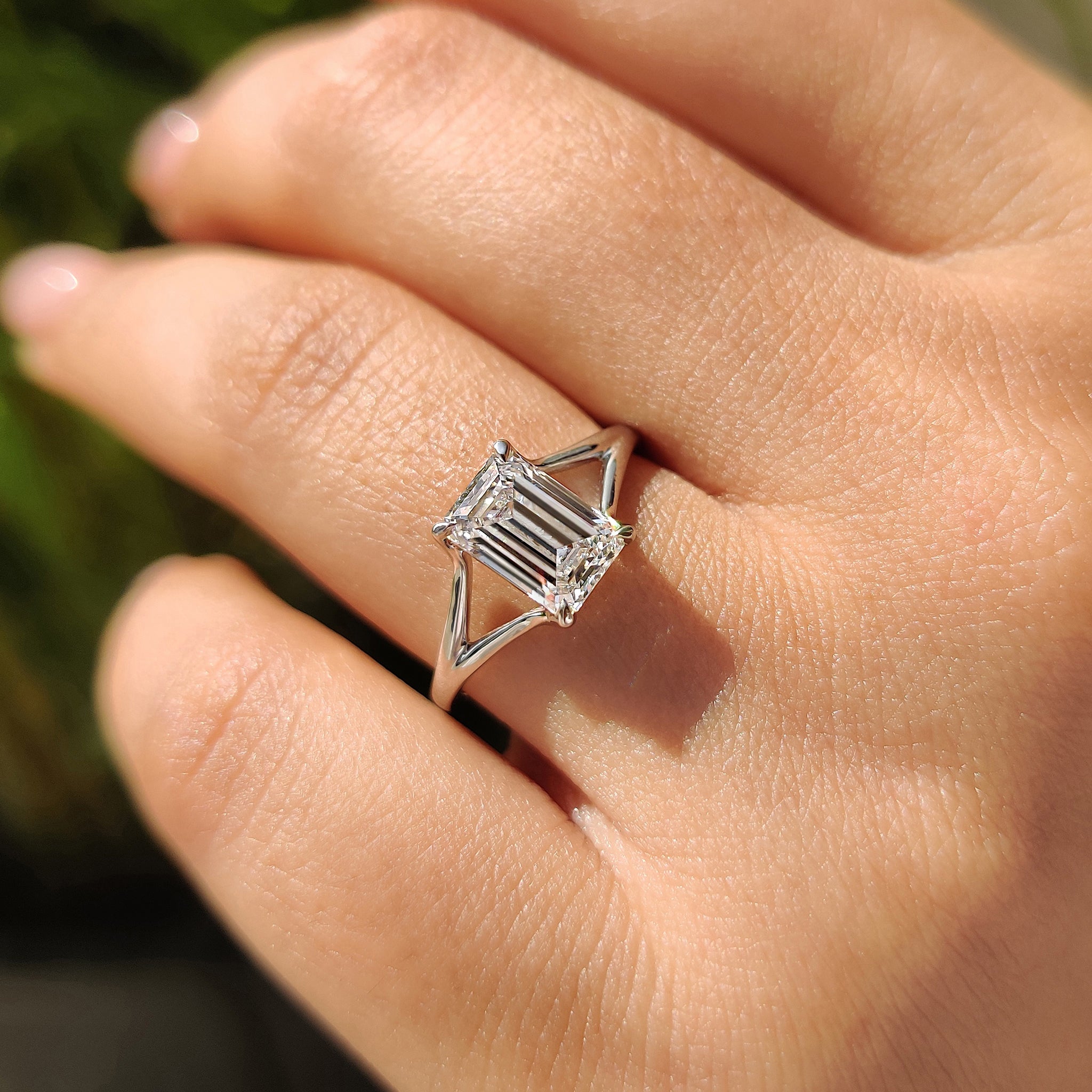 Elegant solitaire diamond ring with a lab-grown emerald cut diamond, presented in a white gold setting, perfect for engagements.
