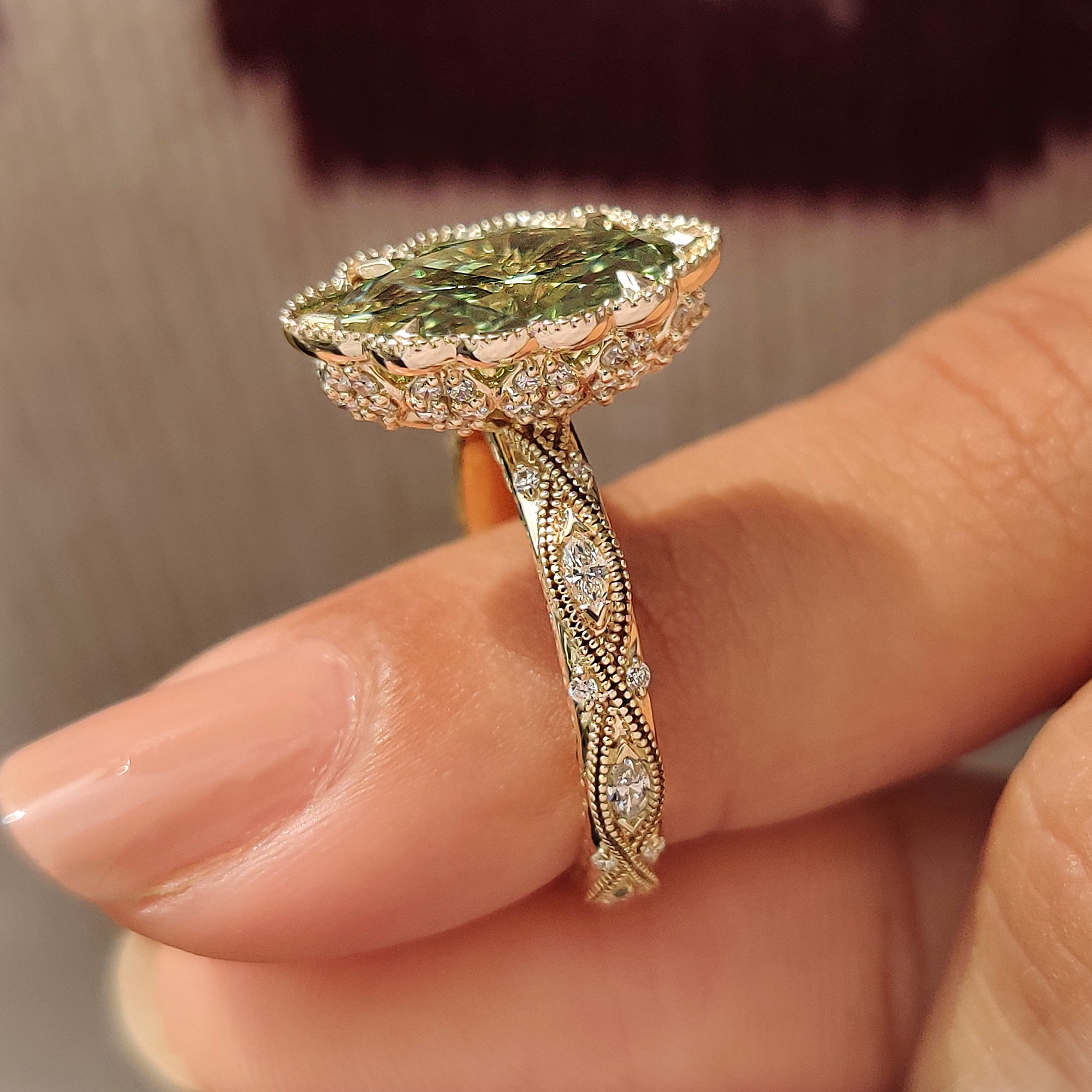 Filigree shank design green marquise diamond ring.
