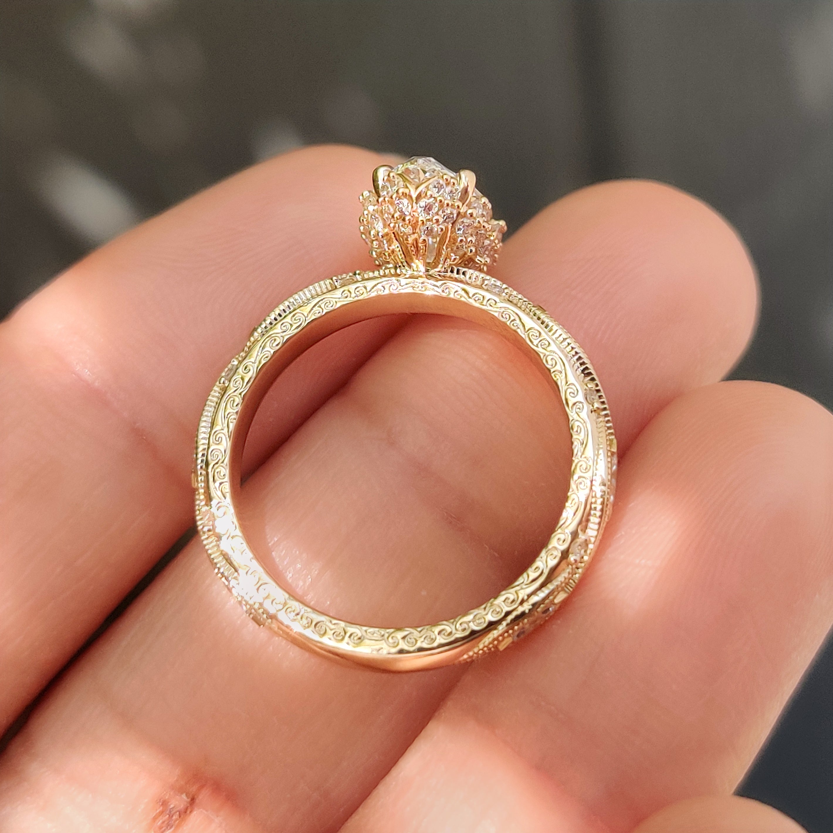 Vintage style marquise diamond ring with round accents.
