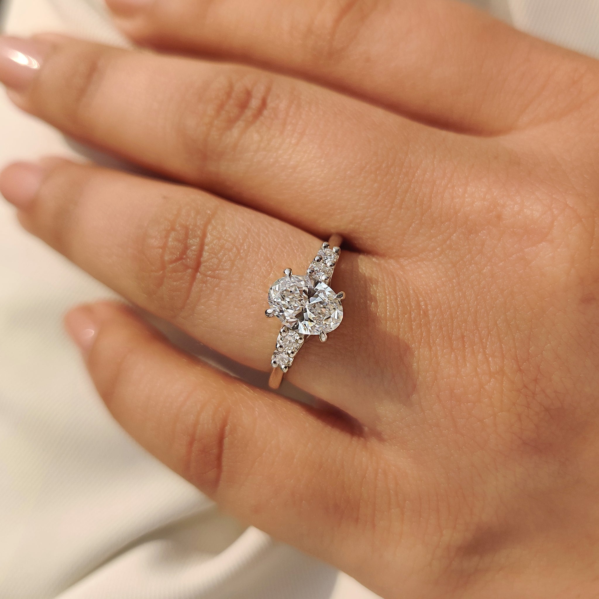 Oval cut diamond ring with structured setting.
