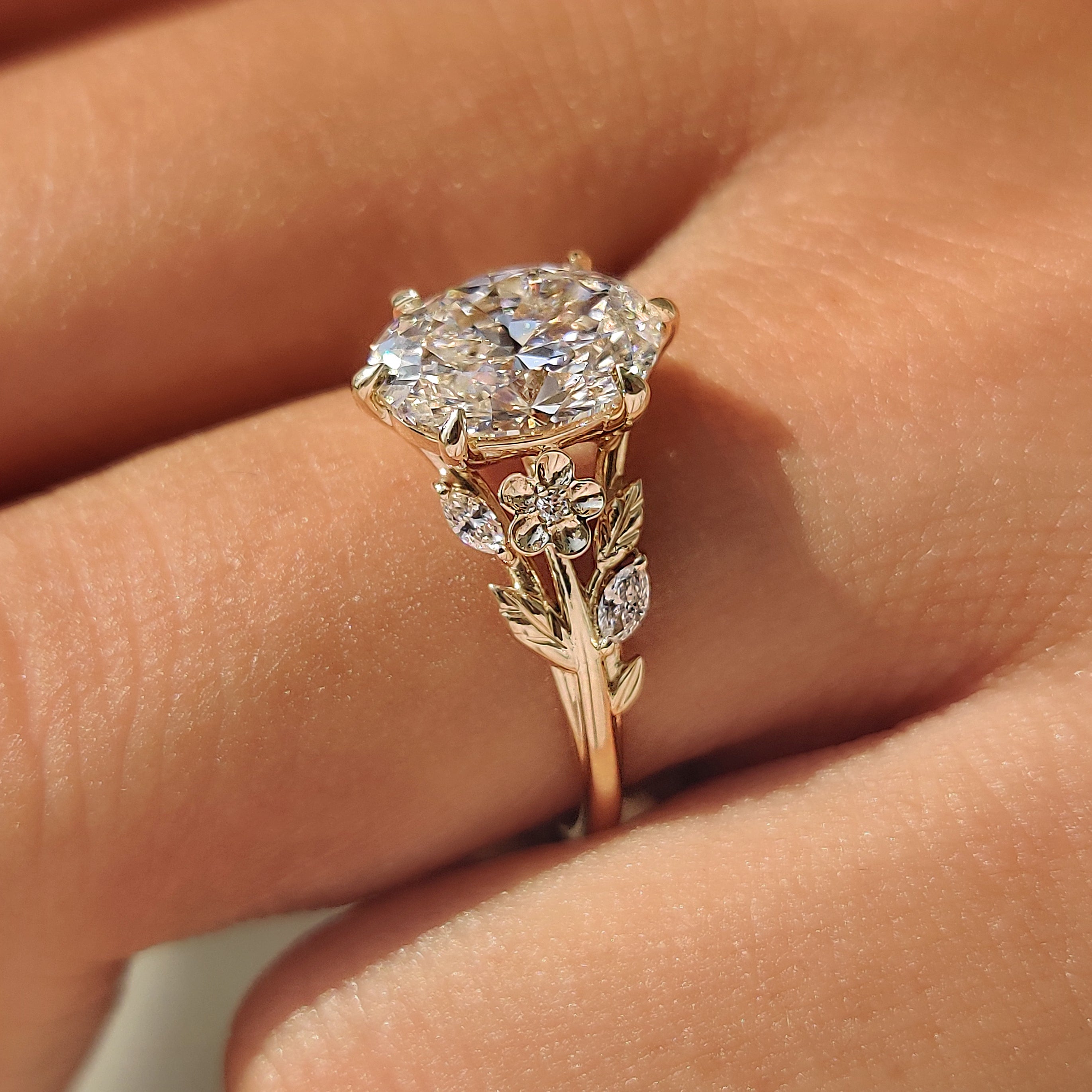 Cherry blossom engagement ring with floral band design.

