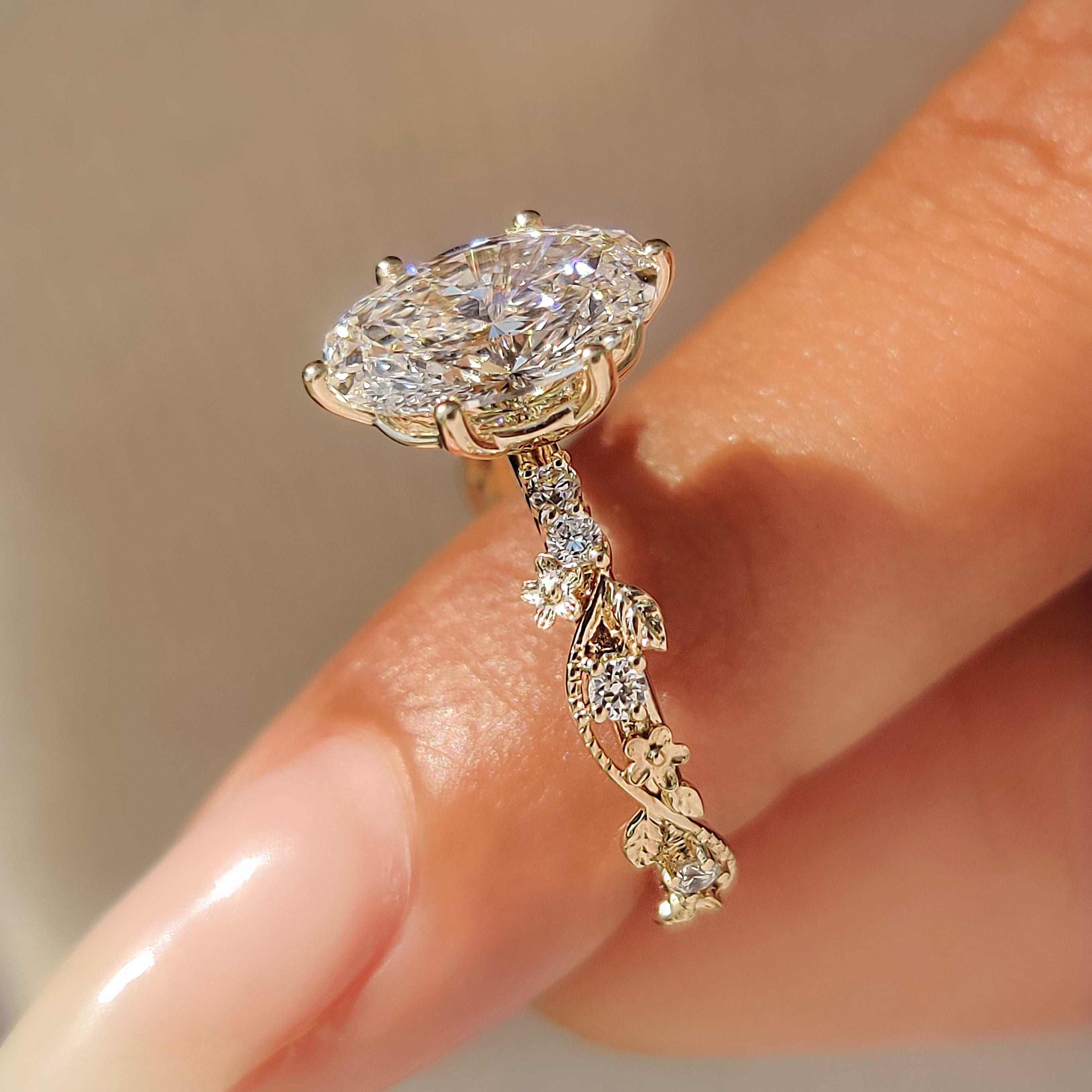 Six prongs securing oval cut center diamond.
