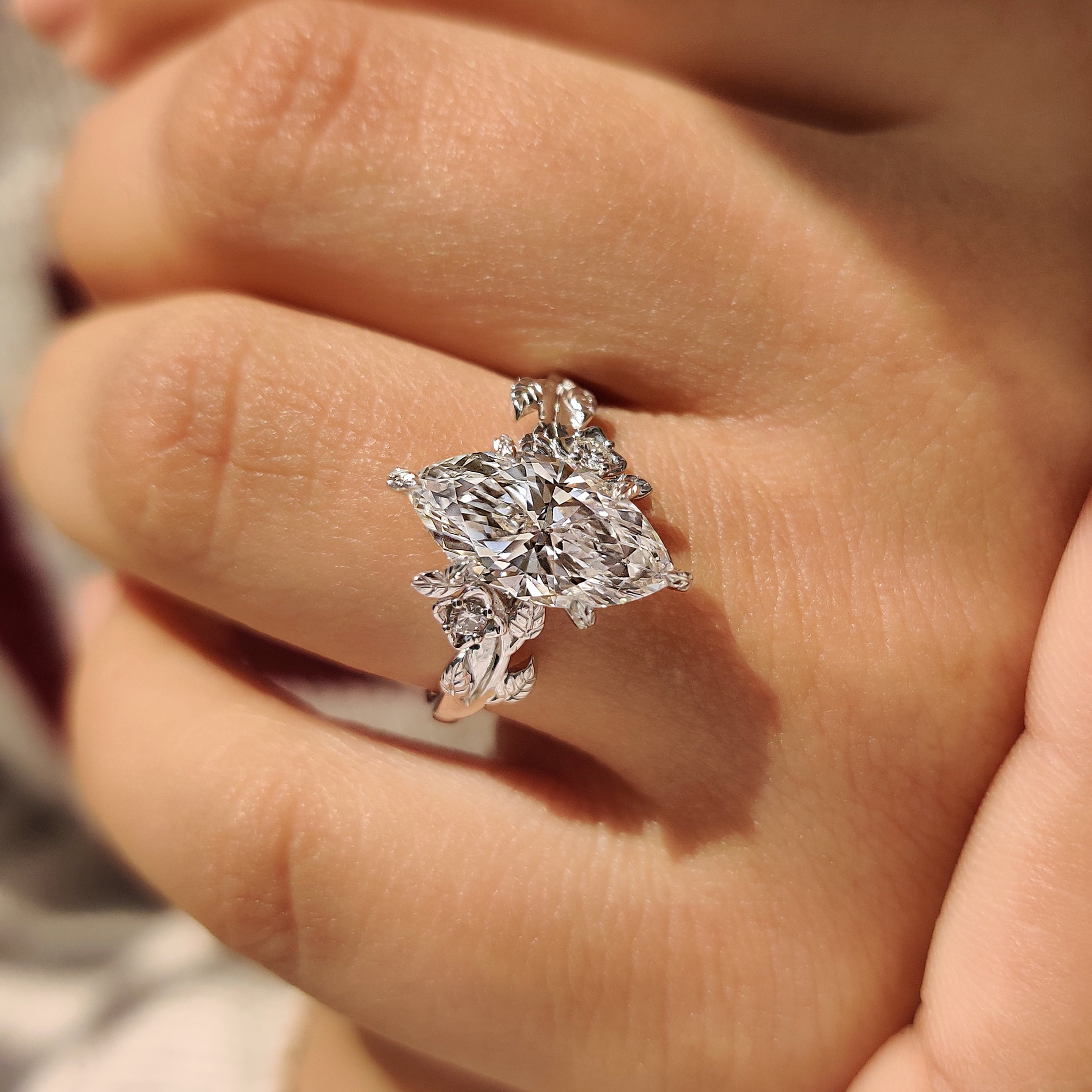 Lab grown marquise diamond ring with leaf style prongs.
