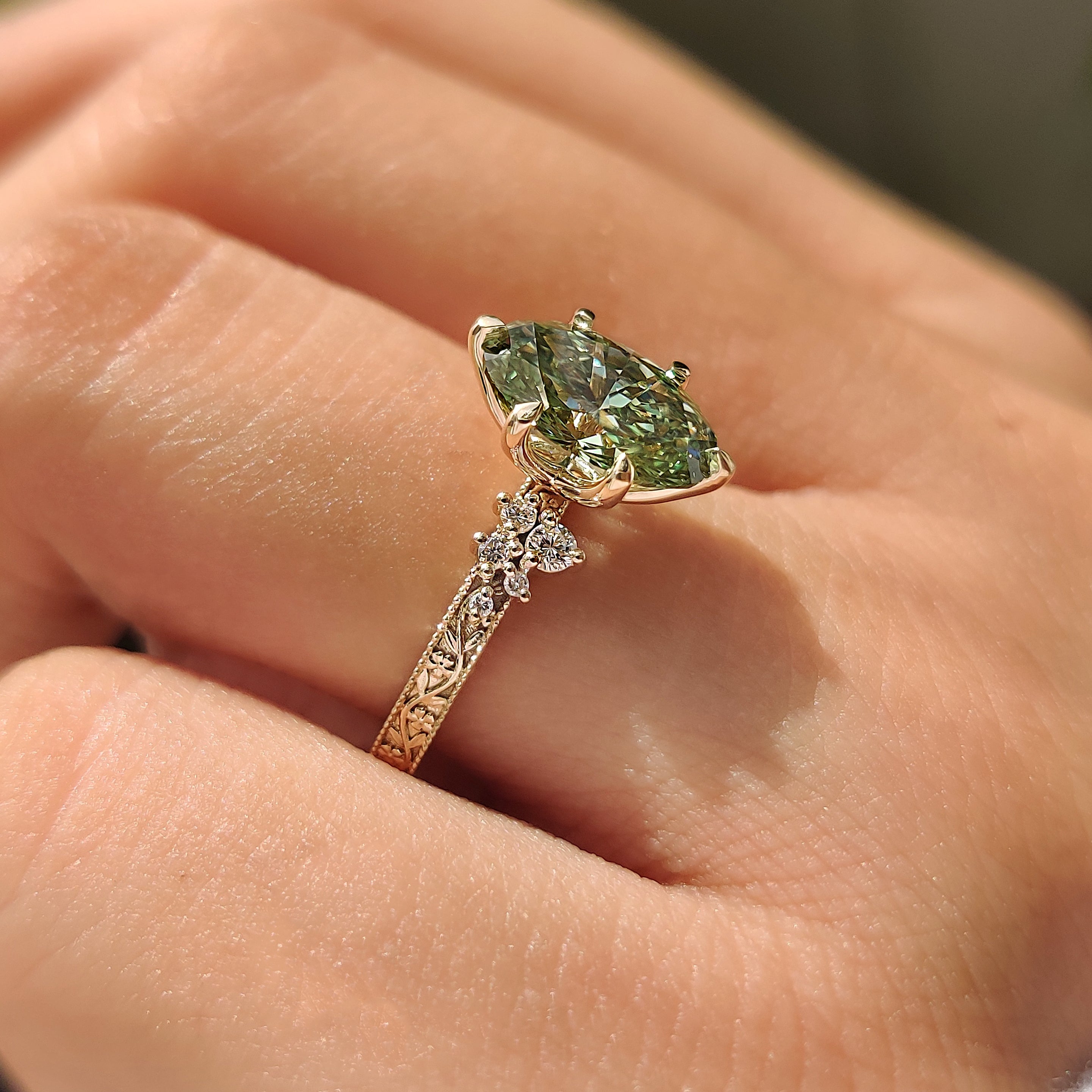Milgrain green oval diamond ring with floral engraved band
