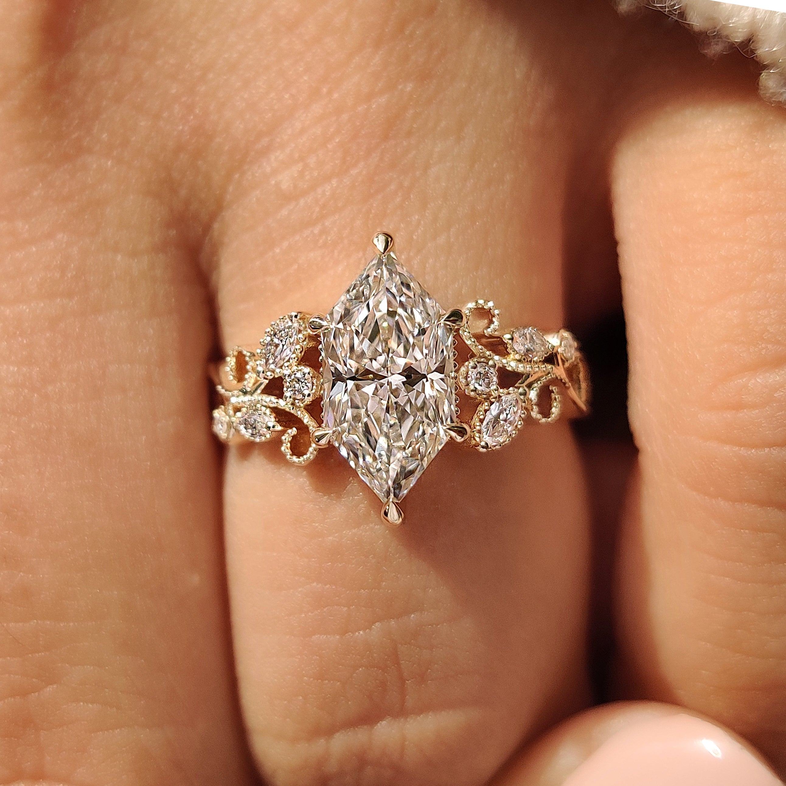 Four claw prong setting holding dutch marquise center diamond
