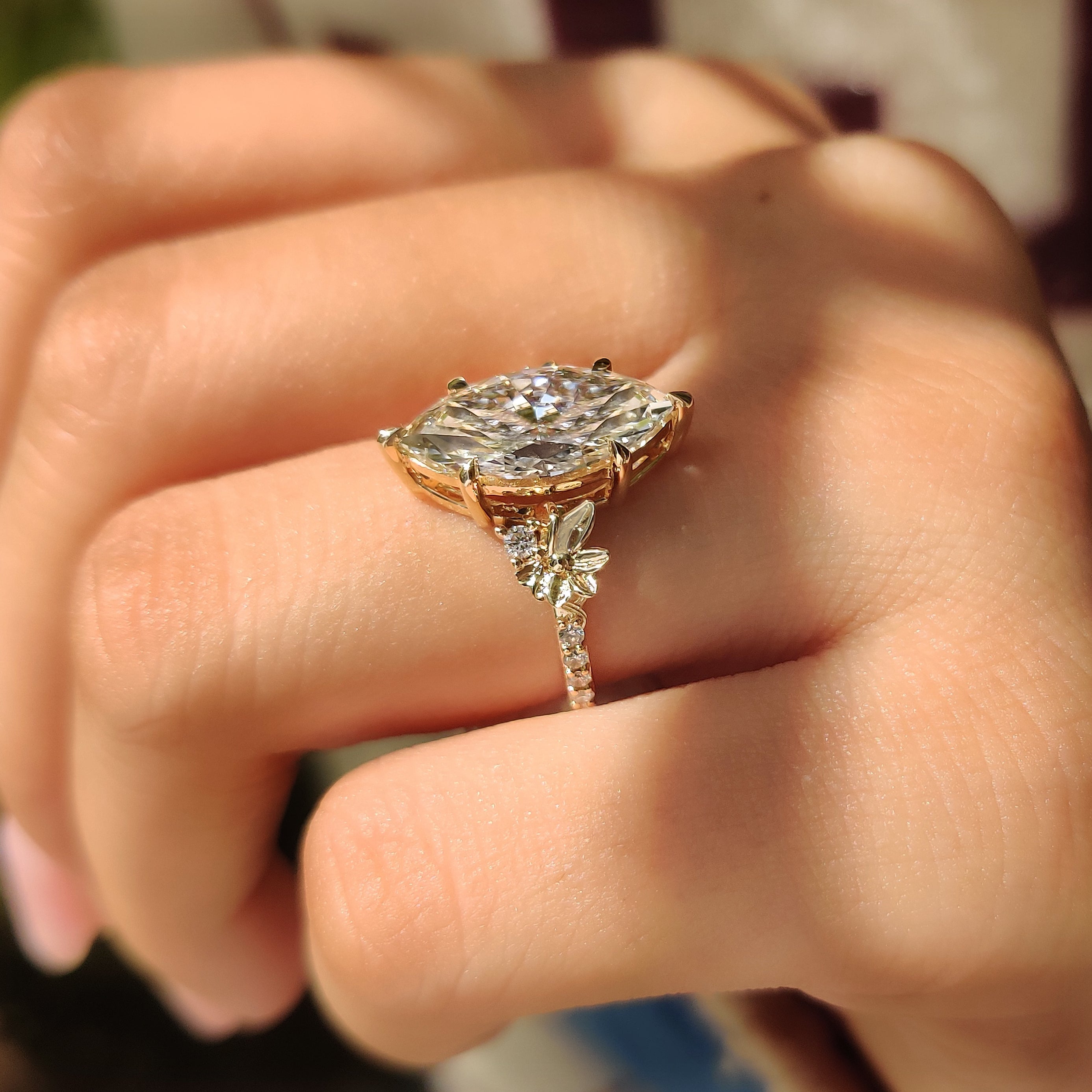 Handmade marquise diamond ring with round side stone setting
