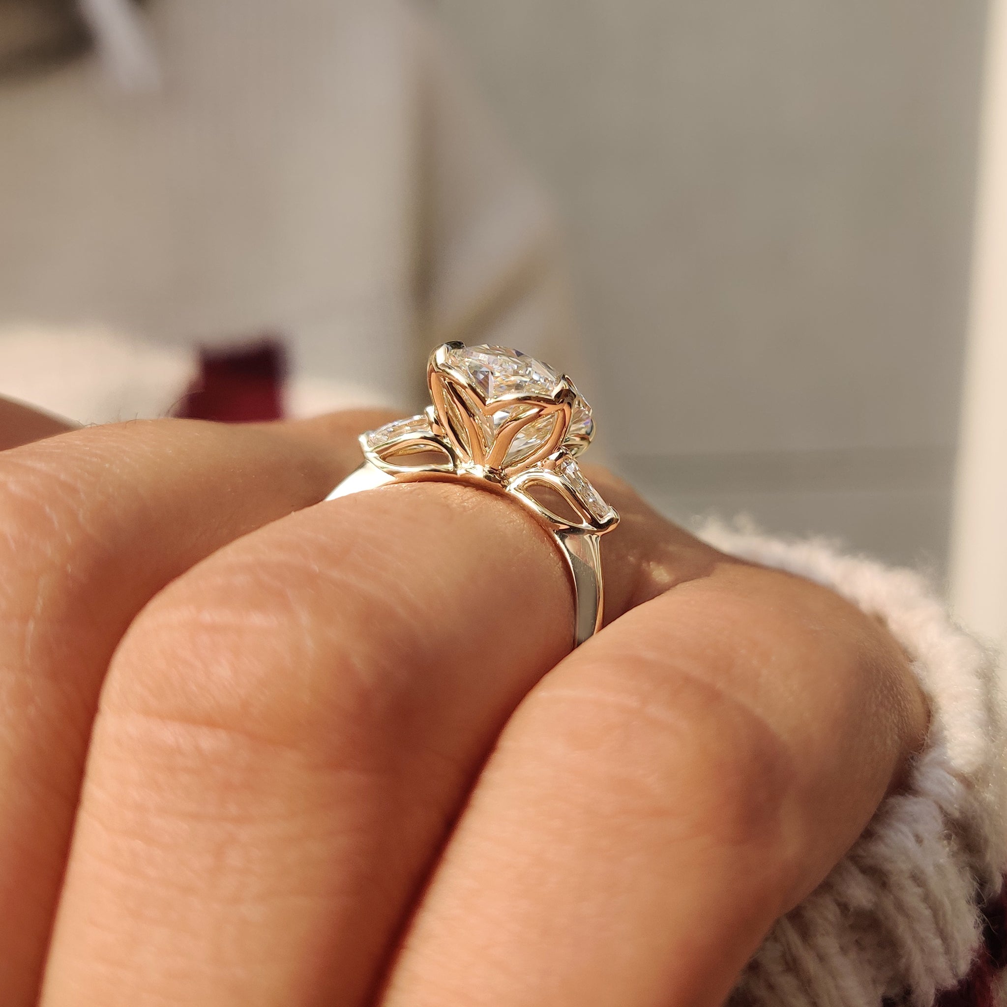 Carat diamond ring with oval center and pear sides
