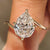 Pear step cut lab grown diamond solitaire bypass ring.
