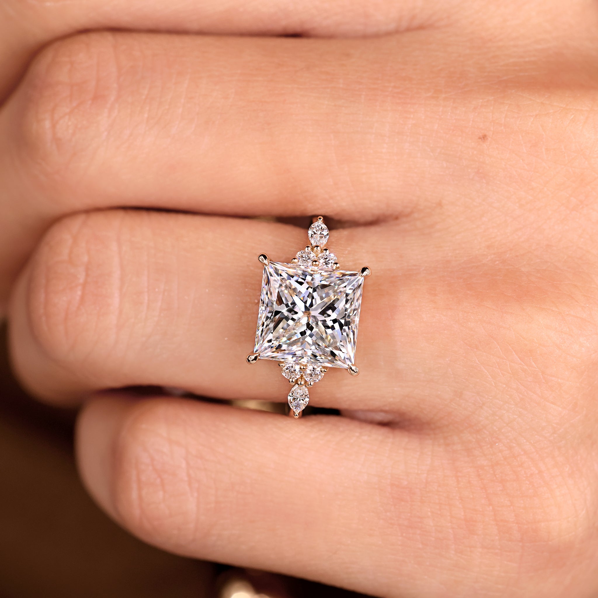Princess cut diamond ring featuring marquise and round stones.
