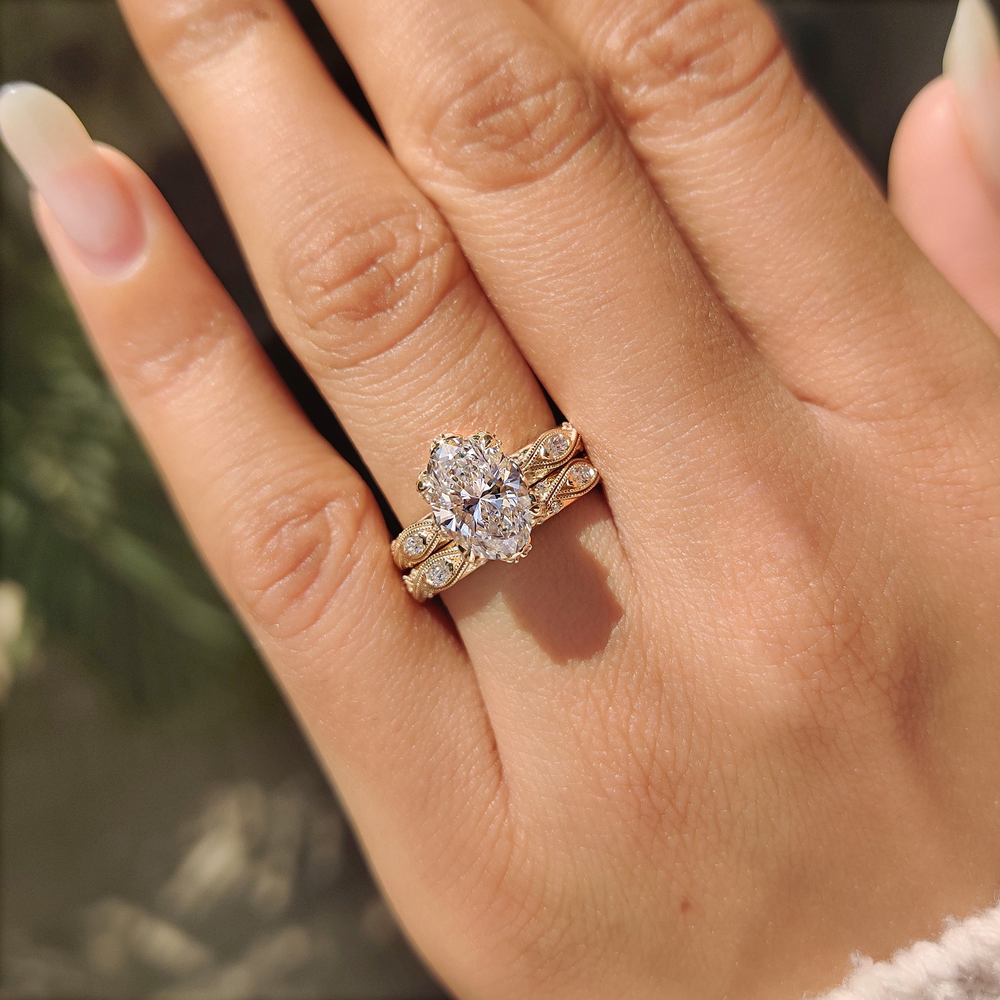 Lab grown oval ring with marquise side stones and hidden accents.
