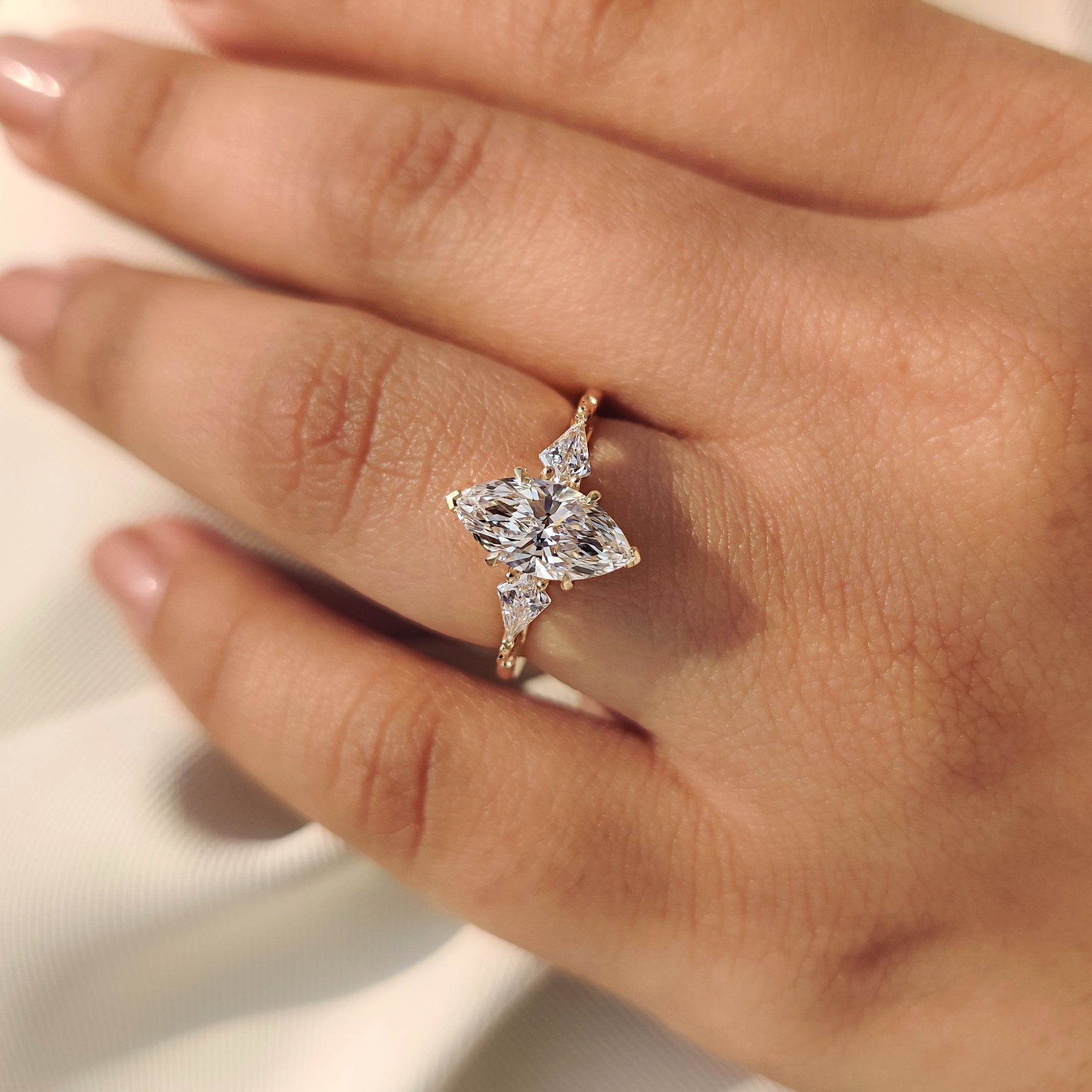 Lab grown marquise diamond ring with four claw prong and V prongs
