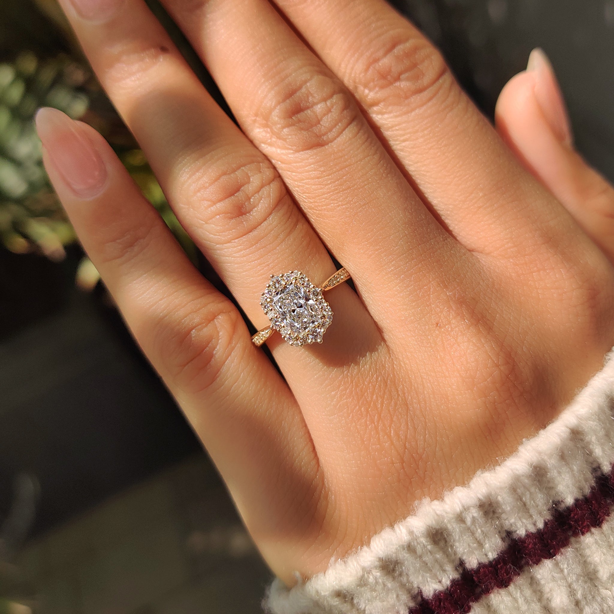 Radiant cut diamond ring with four claw prong setting.

